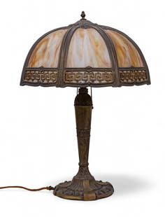 Antique Slag Glass Table Lamp: An early 20th century table lamp featuring a caramel and cream slag glass shade with Greek key border design. The cast metal base has foliate and fluted decoration with twin bulb sockets and original