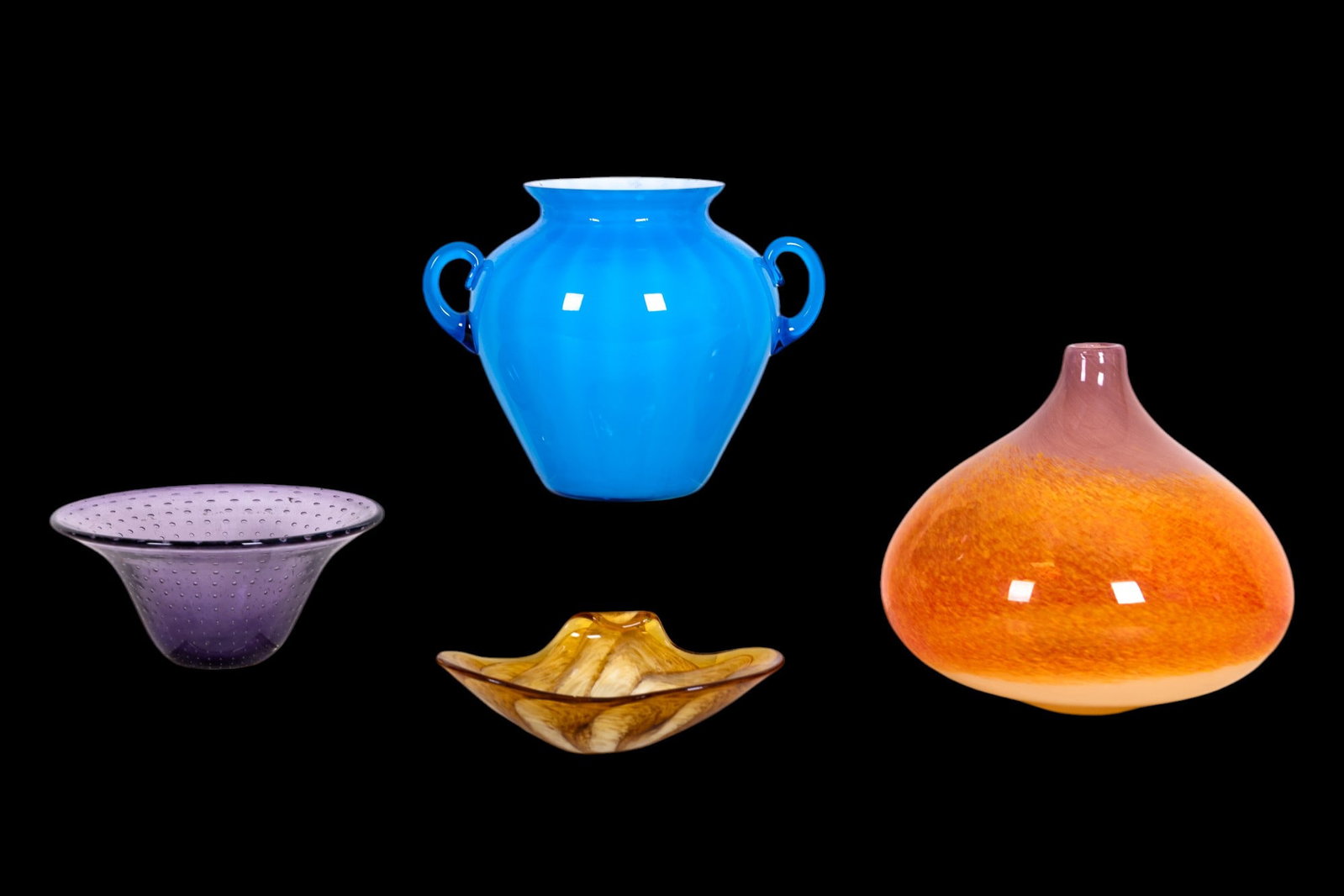 Colorful Art Glass Vessels (4): A grouping of 4 colorful art glass vessels including: an amber swirl heart-shaped bowl, a purple vase with controlled bubbles and clear square base, a vibrant orange teardrop-shaped vase with mottled 