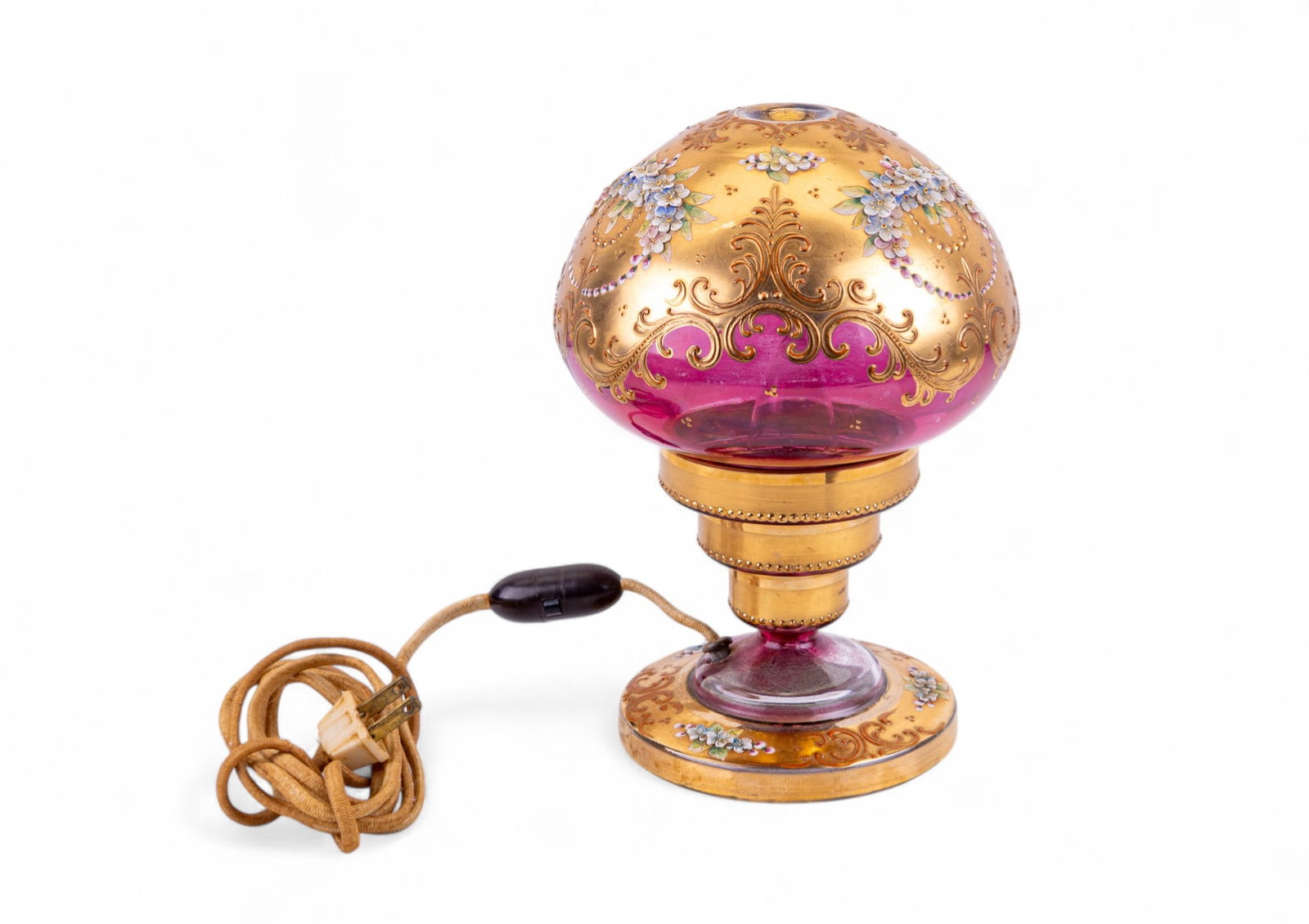 Antique Hand-Painted Glass Mushroom Lamp: Antique glass mushroom-style lamp with pink glass and gilt finish, decorated with hand-painted raised flowers and scroll designs. Features a mushroom-shaped shade and matching base, Wired with older c