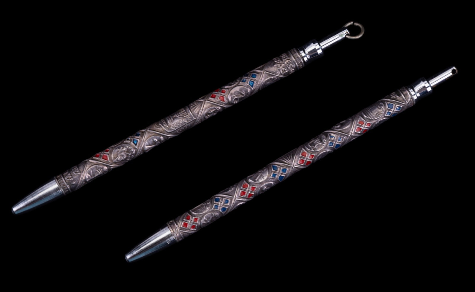 Sterling Silver "Tribes of Israel" Ballpoint Pens: A pair of intricately decorated sterling silver ballpoint pens featuring enameled designs representing the Twelve Tribes of Israel. Each pen is adorned with symbolic motifs and colored enamel highligh