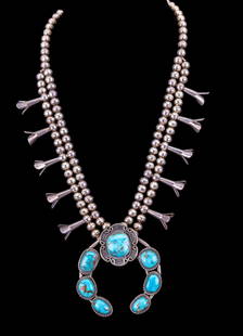 Antique Turquoise Squash Blossom Necklace: Native American early silver squash blossom necklace with large central pendant consisting of 7 large pieces of hand-set turquoise.