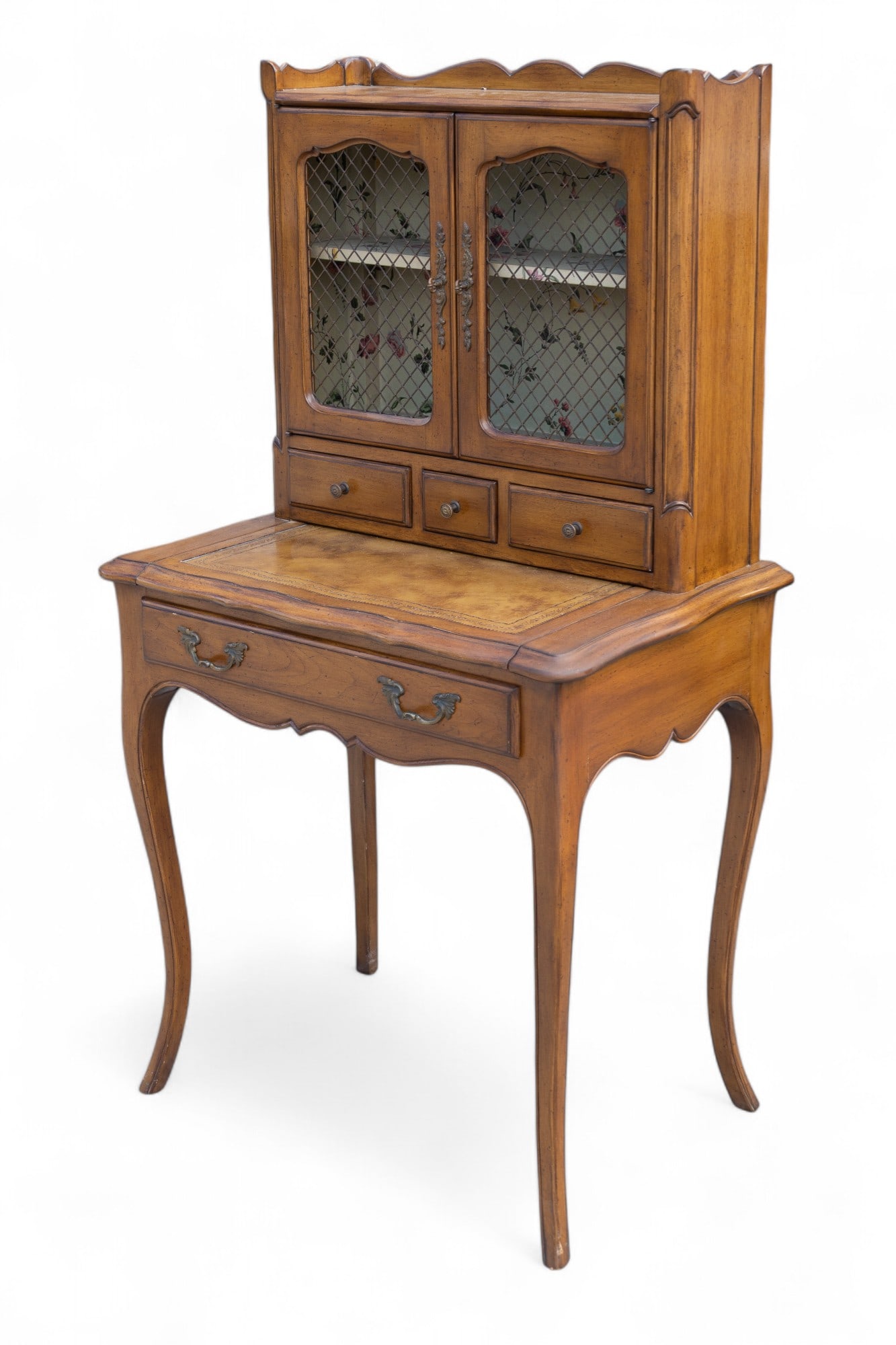 Designer Leather Top Ladies Desk: A designer leather top ladies desk, circa 1930's with slide out writing surface, mesh window panes and 3 drawers over 1 drawer.. Measures approx. 54" H x 29.5" W x 20" D.