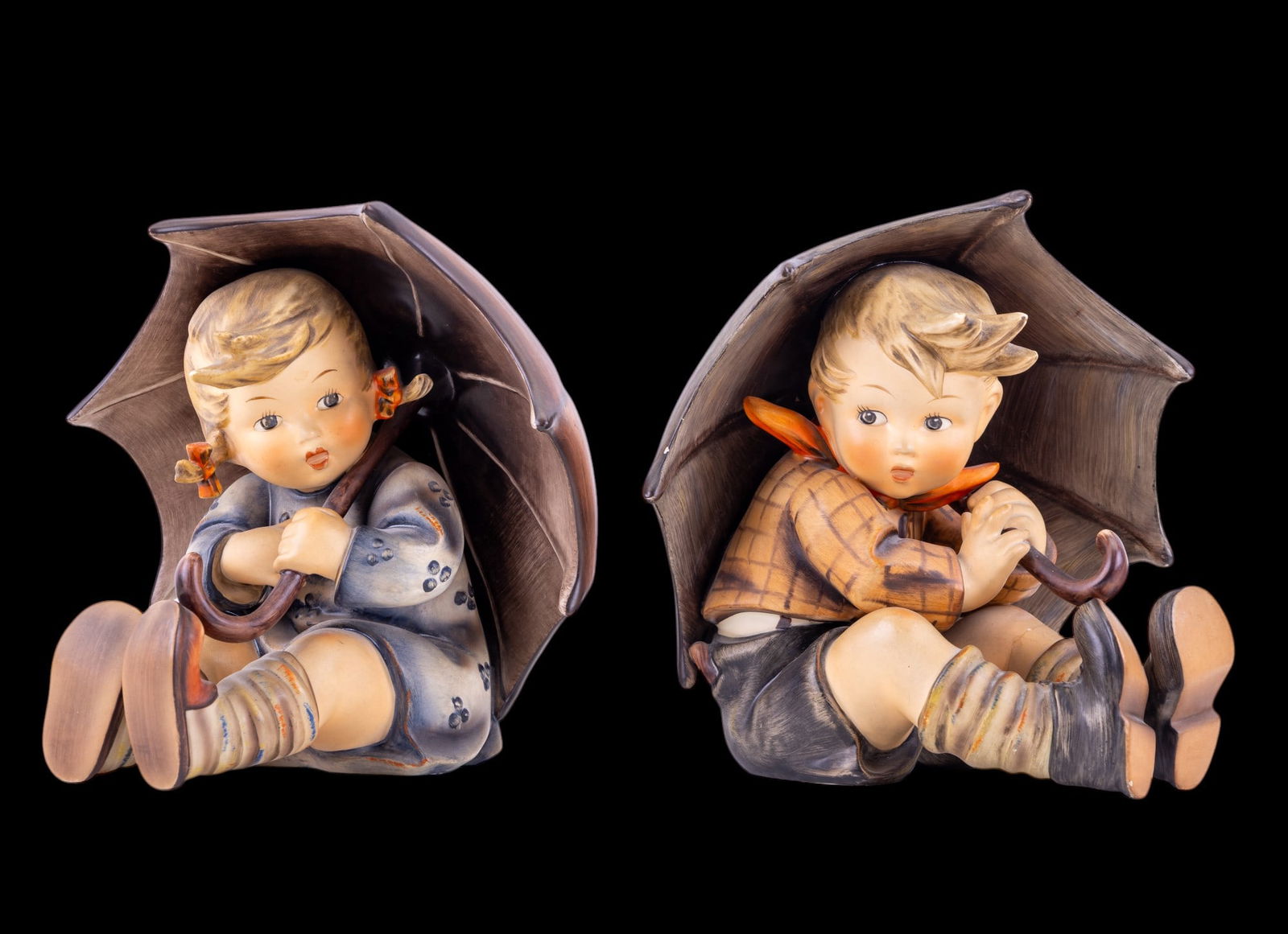 Goebel Hummel Umbrella Boy and Umbrella Girl 152: Goebel Hummel #152A Umbrella Boy TMK 6 figure, featuring a young boy sitting under an umbrella and #152B Umbrella Girl TMK 6 figure, featuring a young girl sitting under an umbrella. Items in excellen