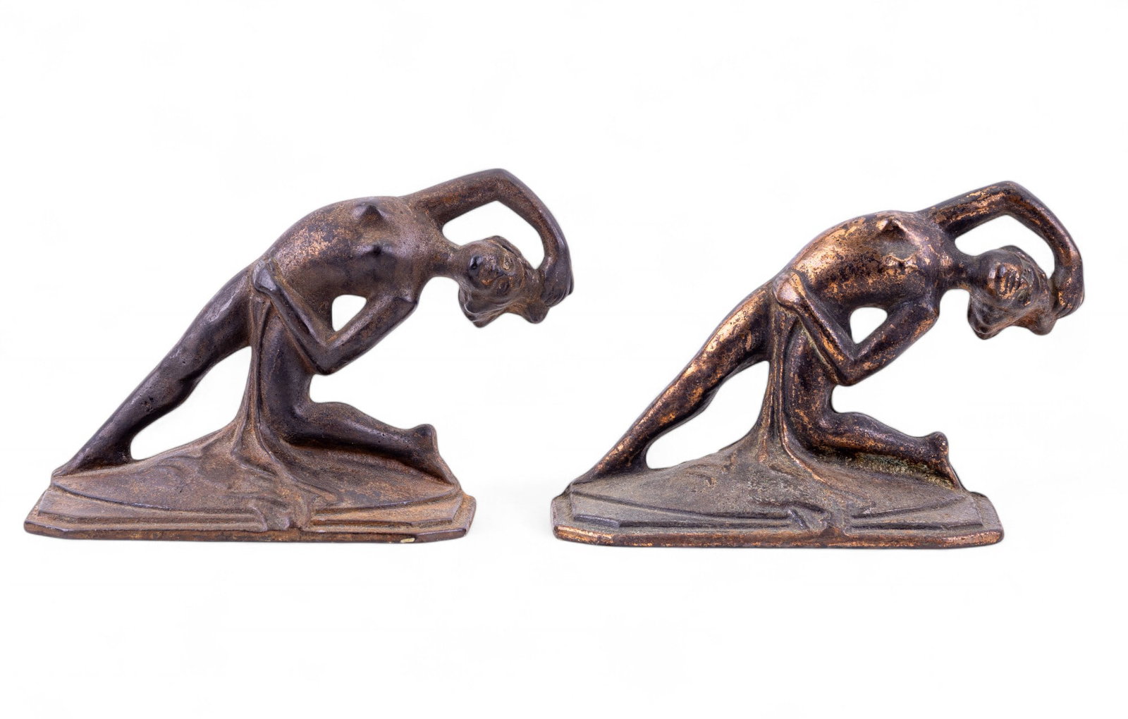 Art Deco Nude Figural Bookends: Pair of cast iron Art Deco bookends, each depicting a stylized nude female figure in a dramatic stretching pose. Each measures approx. 2.25" W x 5.5" D x 4.5" H.