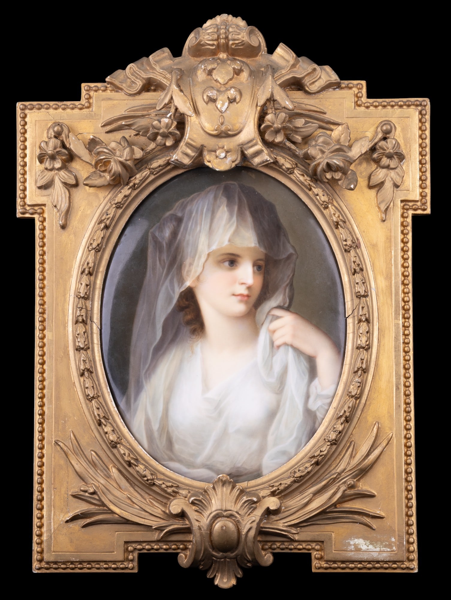 Hand-Painted Porcelain Plaque in Gilt Frame: Finely hand-painted porcelain portrait plaque depicting a young woman / bride draped in white, her veil rendered in delicate translucent detail. Presented in an ornate gilt frame decorated with floral