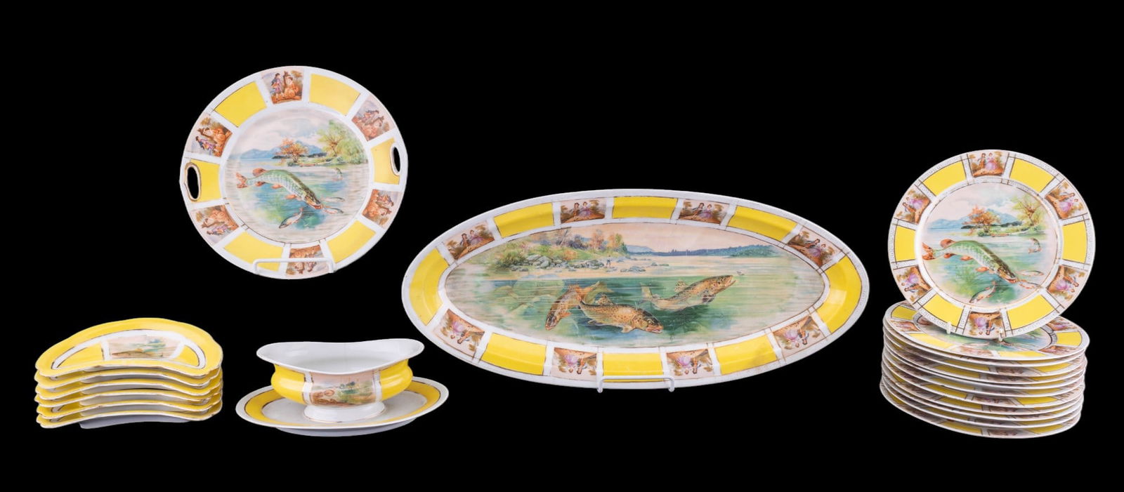 Czechoslovakian Porcelain Fish Service (21): Set of Czechoslovakian porcelain tableware, each piece decorated with fish scenes within bright yellow and white segmented borders. Services includes a large oval platter, fish plates, crescent bone d