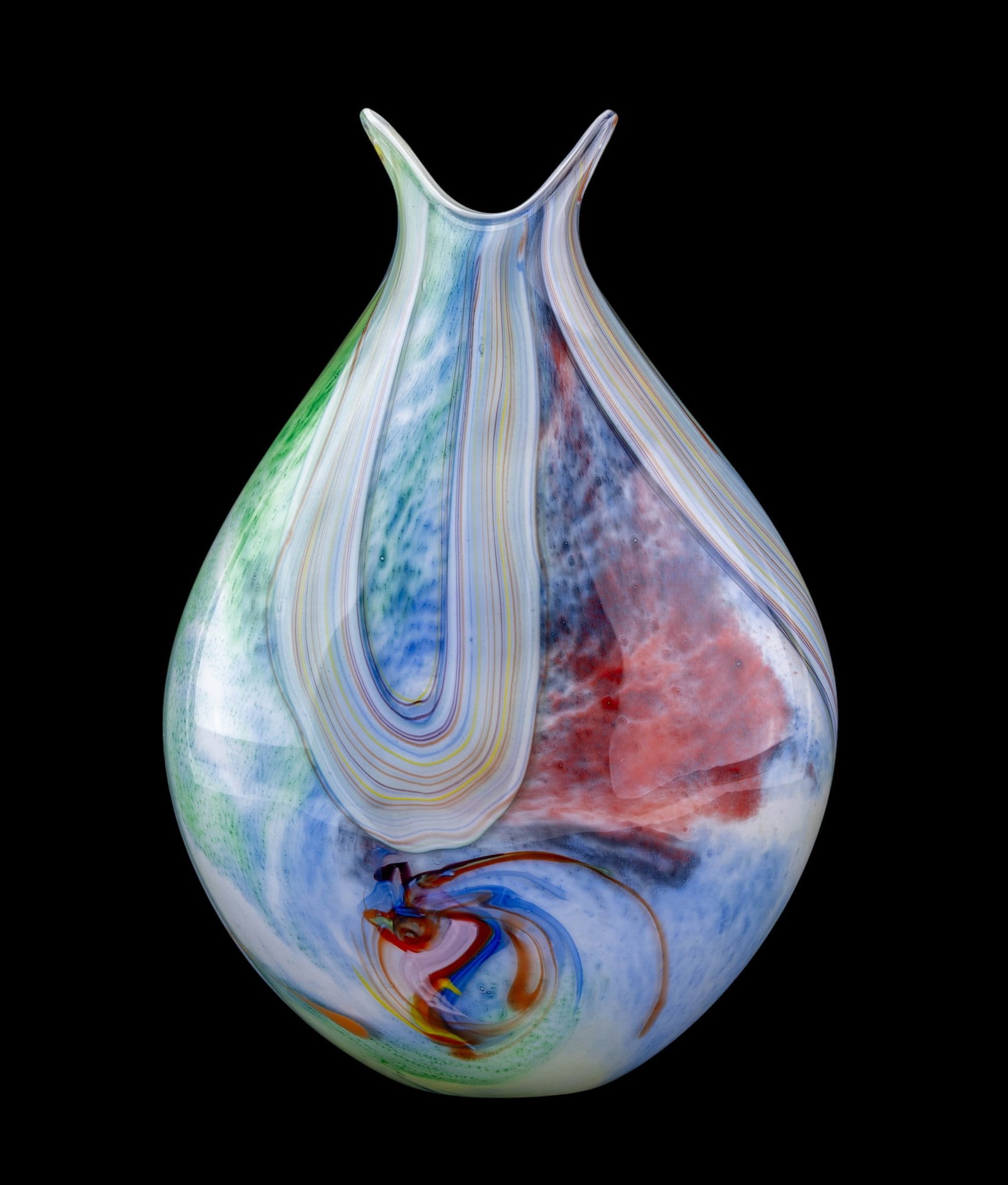 Murano Hand-Blown Art Glass Vase: Murano art glass vase with flared double-point rim. Body displays multicolored ribbon cane swirls in red, yellow, green, and blue over a mottled white ground, with additional layred striations encircl