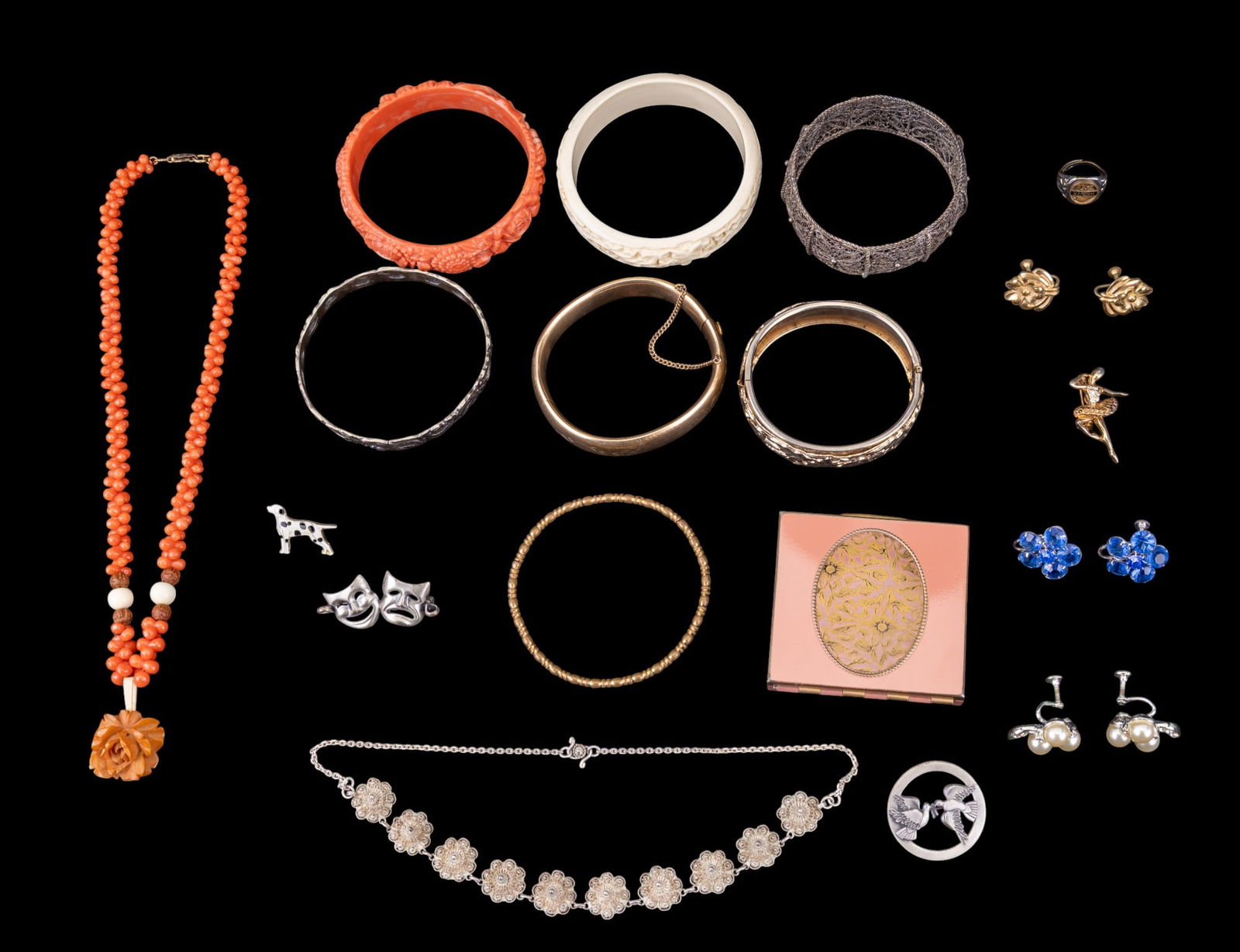 Bangles, Earrings, and Accessories: Jewelry lot containing 7 bangle bracelets of various materials, 2 pairs of screw-back earrings with floral motifs, a sterling silver mask pin, one coral bead necklace, and a compact with a gold-tone f