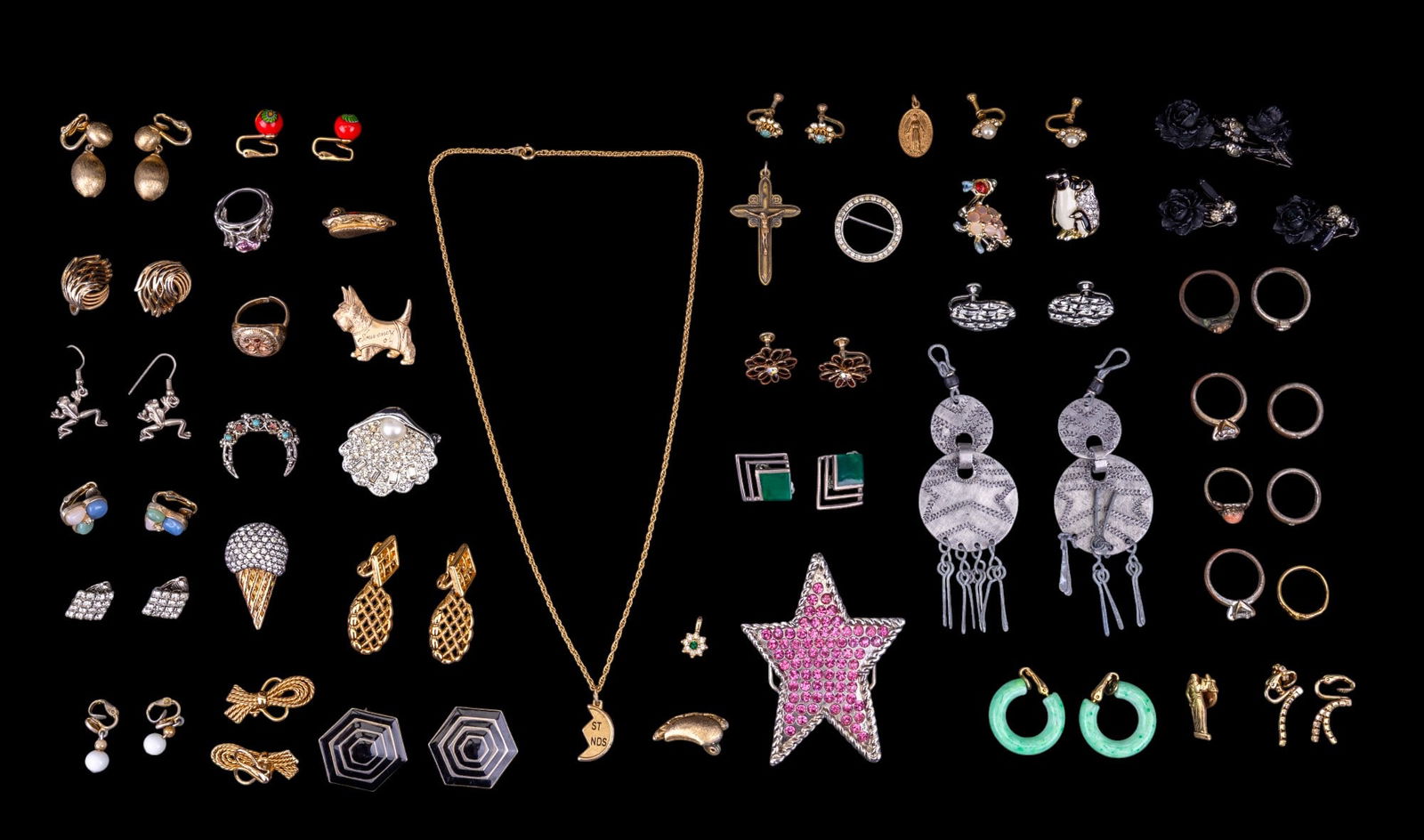 Vintage Designer Costume Jewelry: A collection of vintage costume jewelry featuring rings, brooches, and earrings from designer brands such as Coro, Trifari, Monet, Weiss, and Napier.