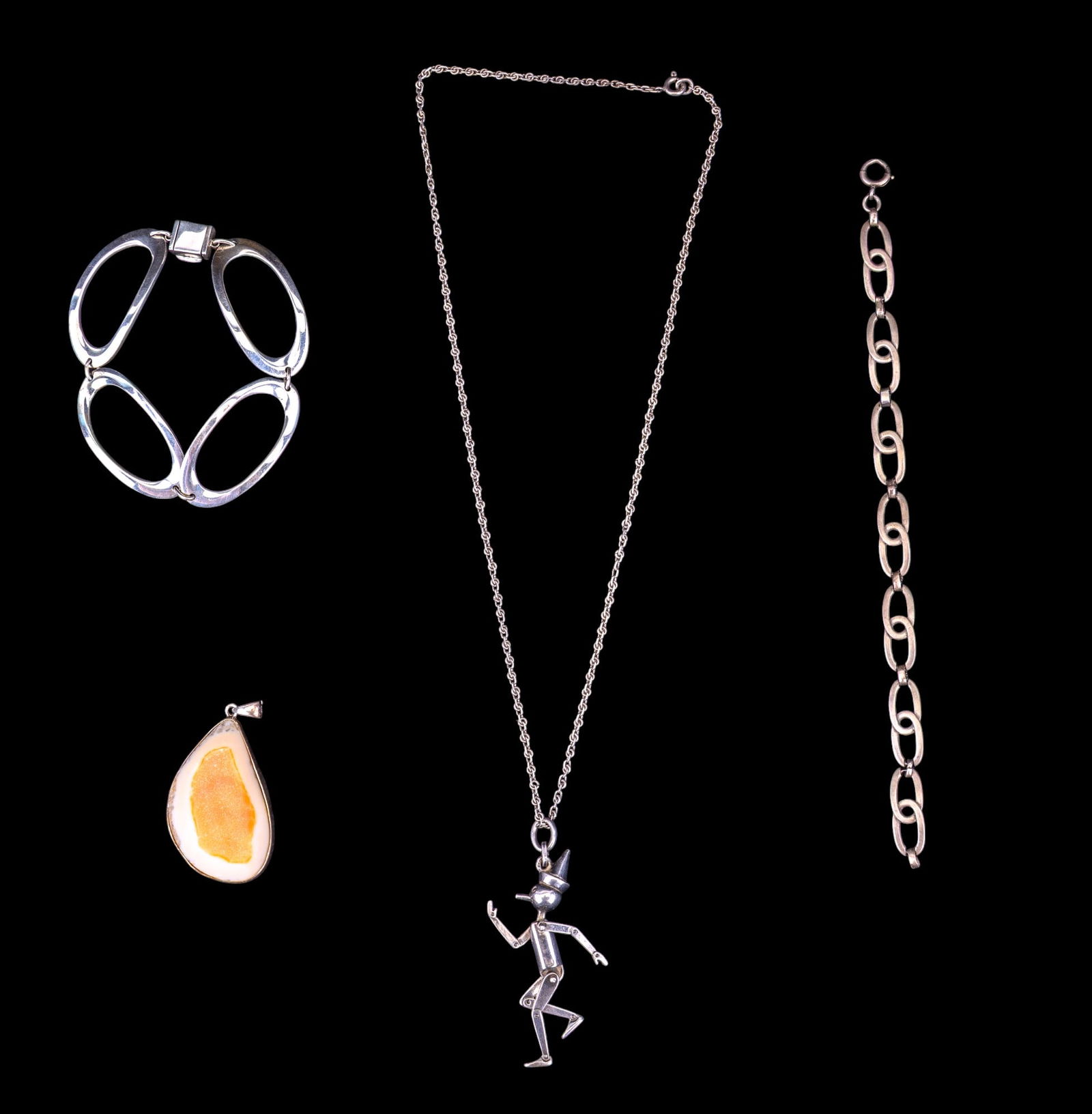 Sterling Silver Bracelets and More: Two sterling silver link bracelets, a sterling set large polished white onyx druzy chunk pendant, and a sterling chain with reticulating Pinocchio charm, charm is unmarked, chain measures approx. 20"