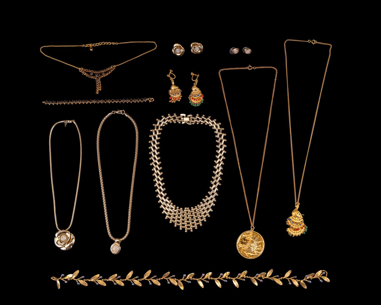 Gold Tone DEsigner Jewelry: A collection of gold tone designer jewelry featuring designers such as Roman, Crown Trifari, Metropolitan Museum of Art, and design elements including black vintage rhinestone necklace and bracelet se