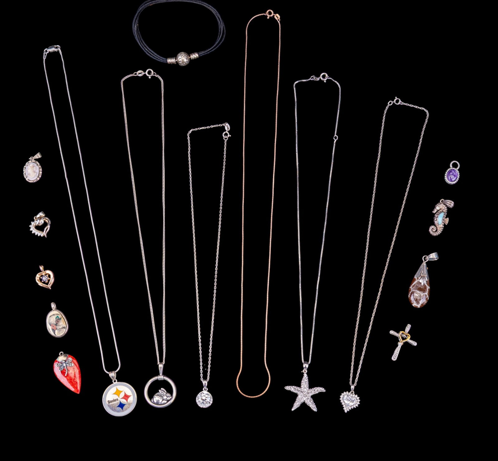 Sterling Silver Necklaces and Pendants: A collection of sterling silver chains and pendants featuring rose gold and box chains, Pittsburgh Steelers sterling and enamel pendant, oval bird scrimshaw pendant, Pandora string charm bracelet, and