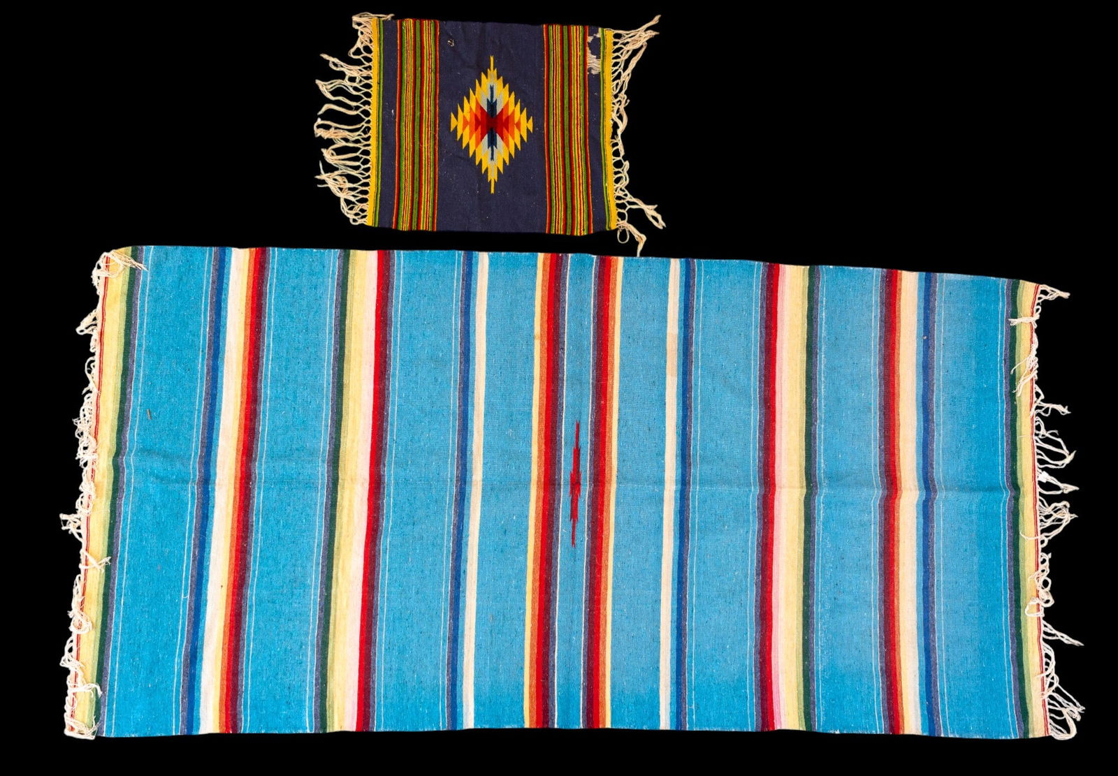 Southwestern / Navajo Handwoven Textiles: 2 handwoven Southwestern/Navajo wool textiles. 1 features striped serape design with multicolor bands against a turquoise ground, the other with central diamond geometric motif. Larger measures approx