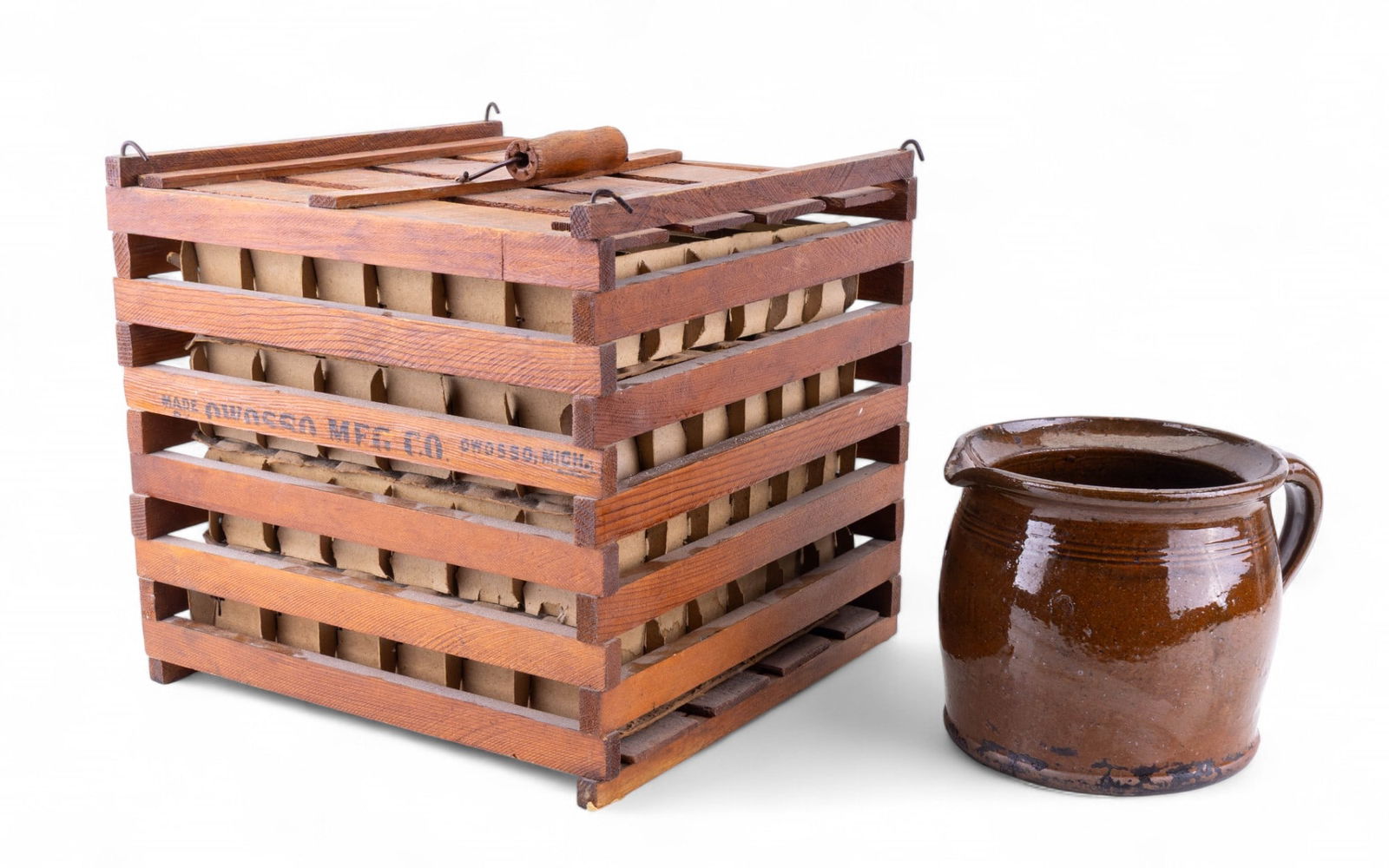 Antique Humpty Dumpty Egg Crate + Redware Jug: Antique wooden Humpty Dumpty egg crate made by Owosso MFG Co of Owosso, MI, measures approx. 12" on all sides, and a short early dark brown speckle glazed redware pitcher jug, measures approx. 9" Diam