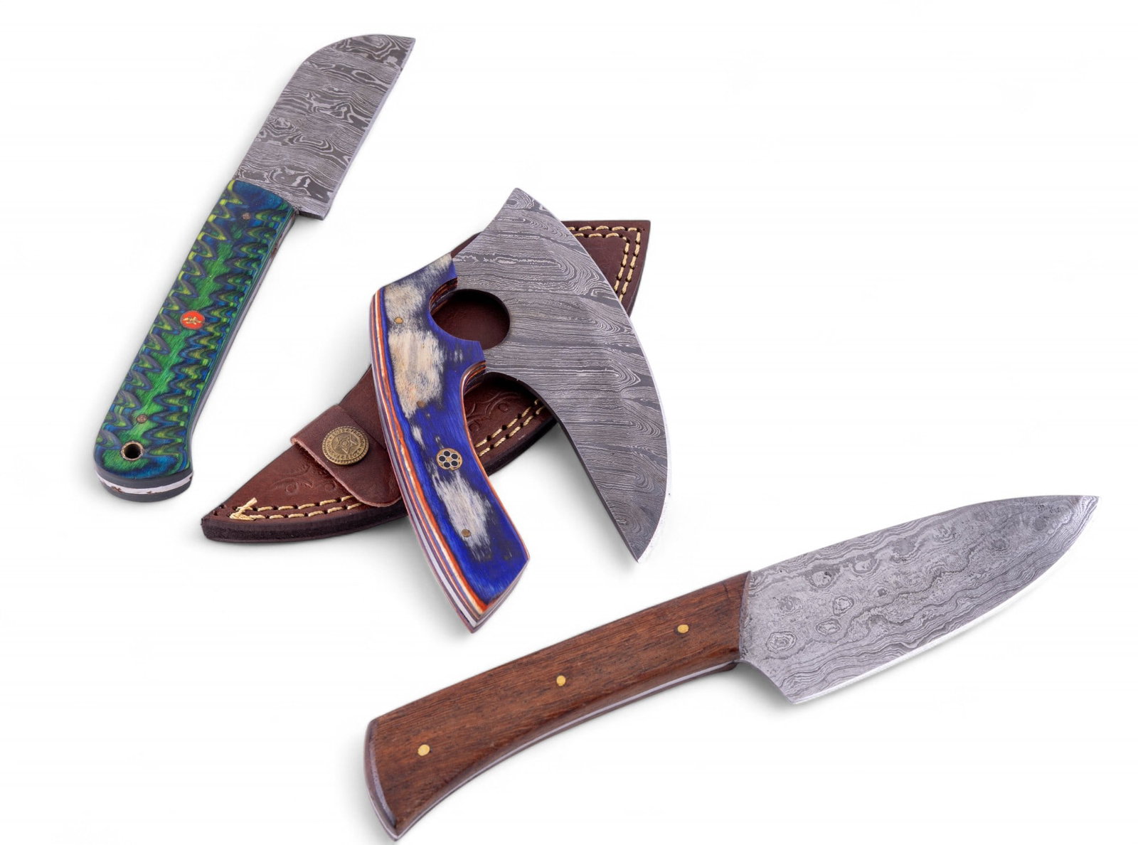 MHS Cutlery Damascus Steel Knives: A collection of MHS Cutlery Damascus steel cooking knives featuring dyed wood and solid wood carved handles, featuring two small paring knives, and an Ulu knife. The Ulu knife has a stamped genuine le