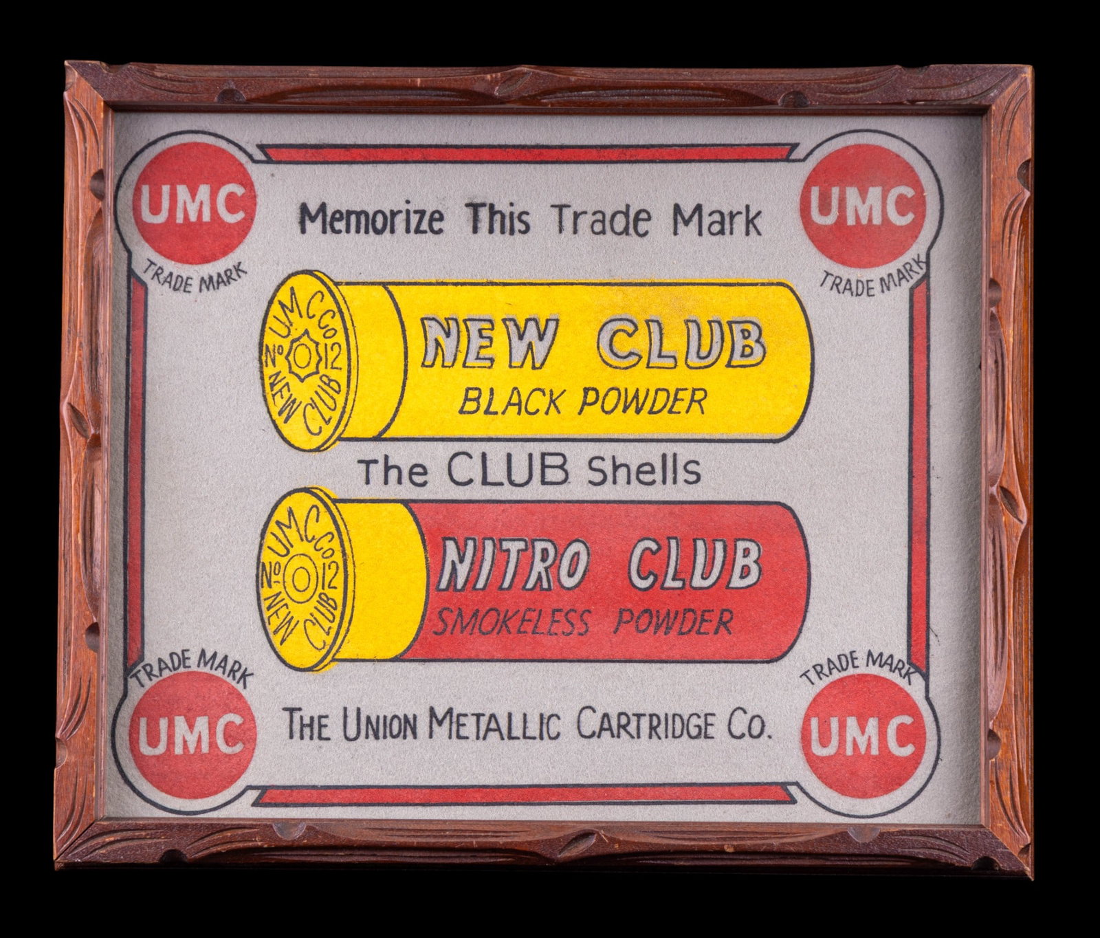 UMC Shot Shell Countertop Mat in Frame: Union Metallic Cartridge Co. advertising felt countertop mat, designed for use in gun shops as point-of-sale display. Features red and yellow graphics of Nitro Club Smokeless Powder and New Club Black
