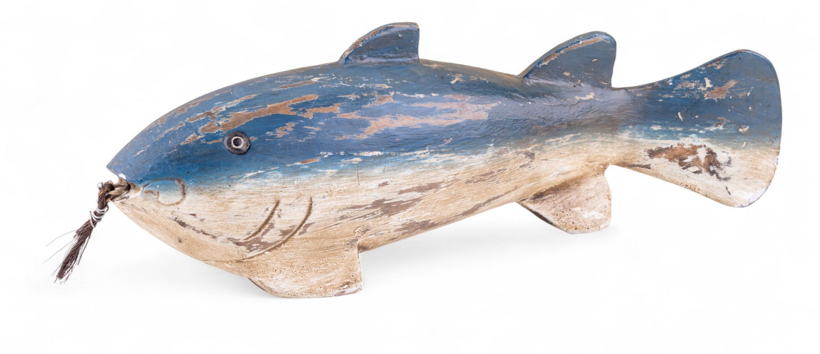 Carved Wooden Fish Decoy: Hand-carved wooden fish decoy with painted surface in shades of blue and tan. Features wire loop at mouth with bristle detail. Measures approx. 11".