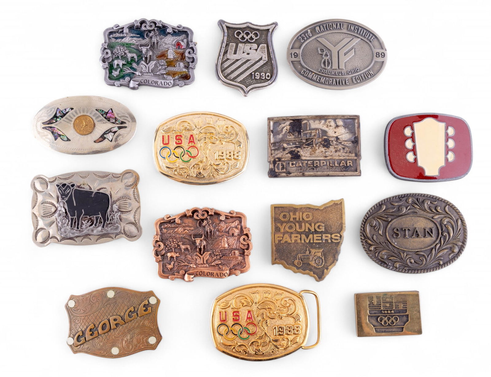 Belt Buckles (14): A collection of mostly solid brass belt buckles featuring vintage Olympics buckles from the 1980s, Native American style belt buckles with abalone and onyx inlay, personalized buckles, and more.