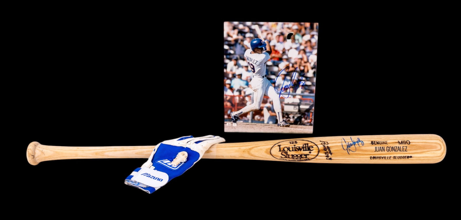 Juan Gonzales signed Memorabilia: A collection of signed collectible memorabilia including a baseball bat, 8x10 photo, and unsigned, game used batting gloves featuring the signature of Juan Gonzales. Hand written letter accompanies th