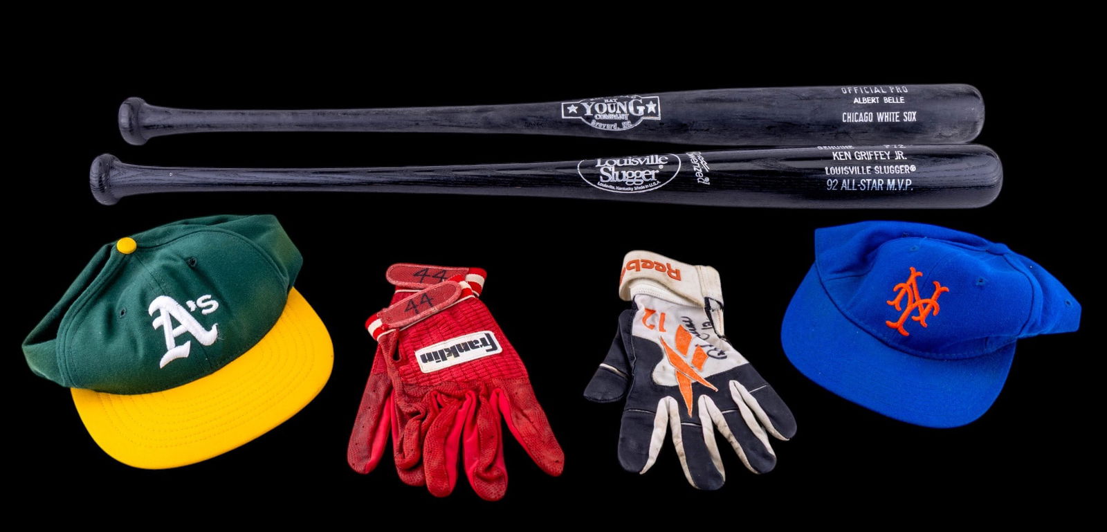 MLB Player Memorabilia: A collection of MLB player memorabilia including a New York Mets hat, an Oakland Athletics hat, a pair of used red Franklin batting gloves, one signed Reebok black and orange glove featuring the numbe