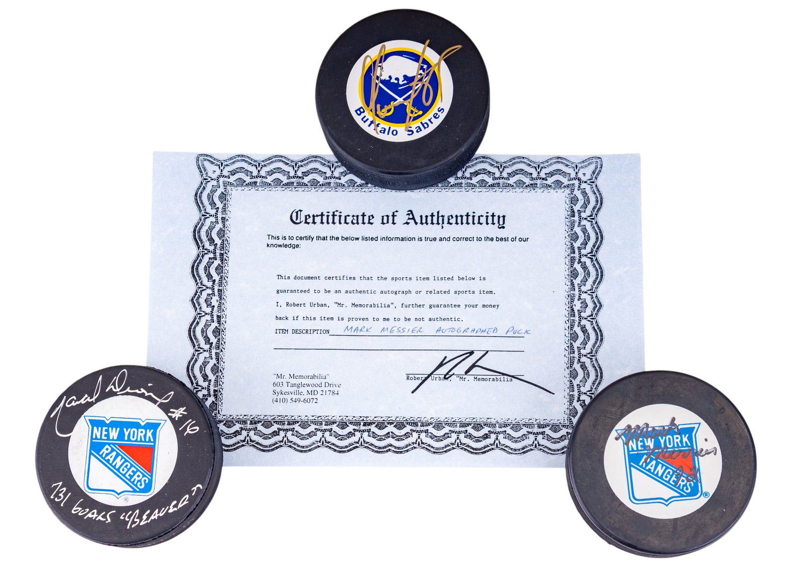NHL Signed Pucks: Messier, Dionne, & Other: A collection of three NHL player signed hockey pucks featuring signatures of Mark Messier, including COA, Marcel 'Beaver' Dionne, no COA, and an unidentified signed Buffalo Sabres puck.