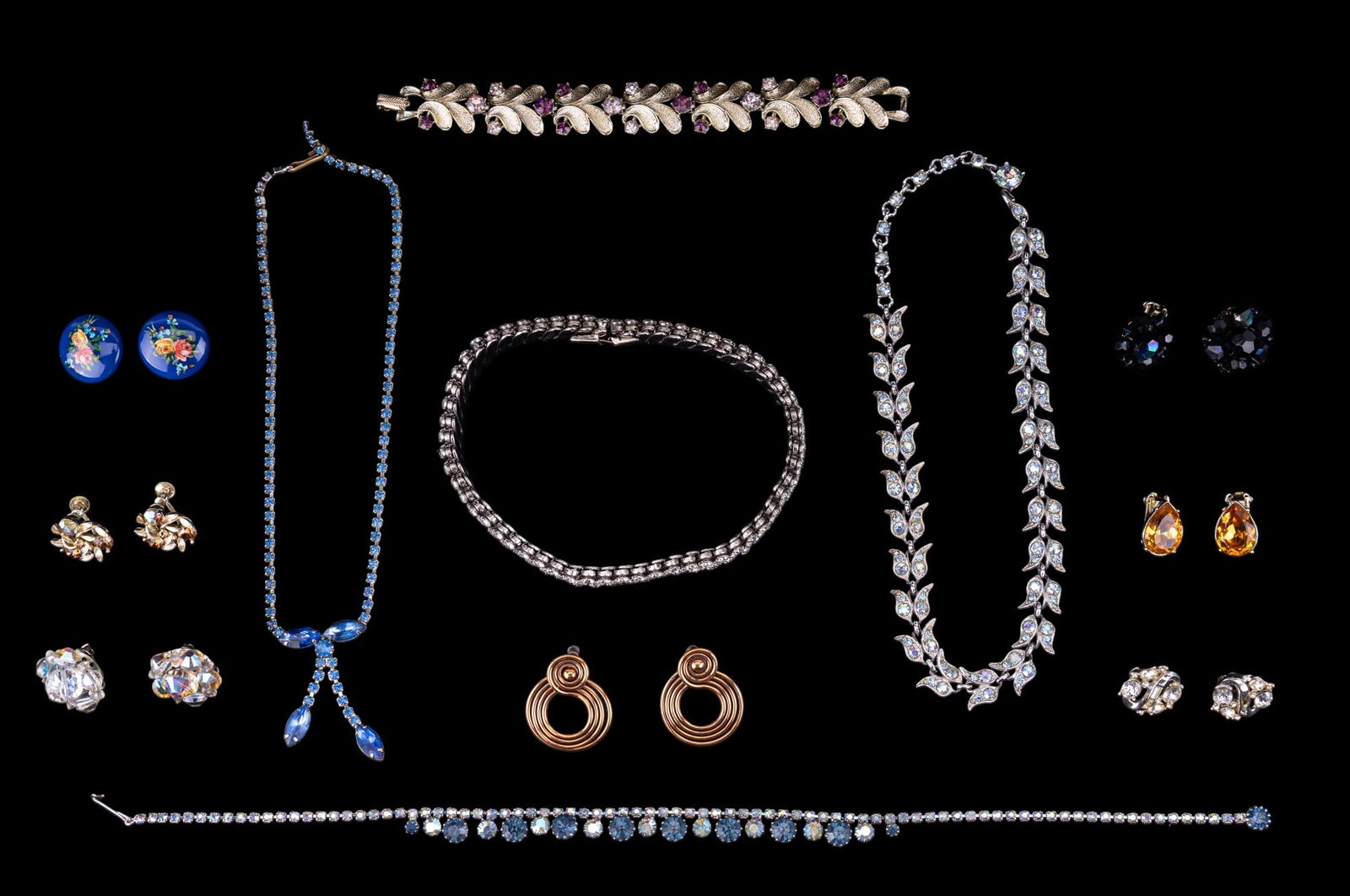 Trifari, Coro, and Early Estate Jewelry: Includes: Coro leaf design bracelet with pink accents, early Trifari round crystal rhinestone clips, Lisner screwback earrings, bright blue necklaces, earrings, and wide crystal rhinestone necklaces.