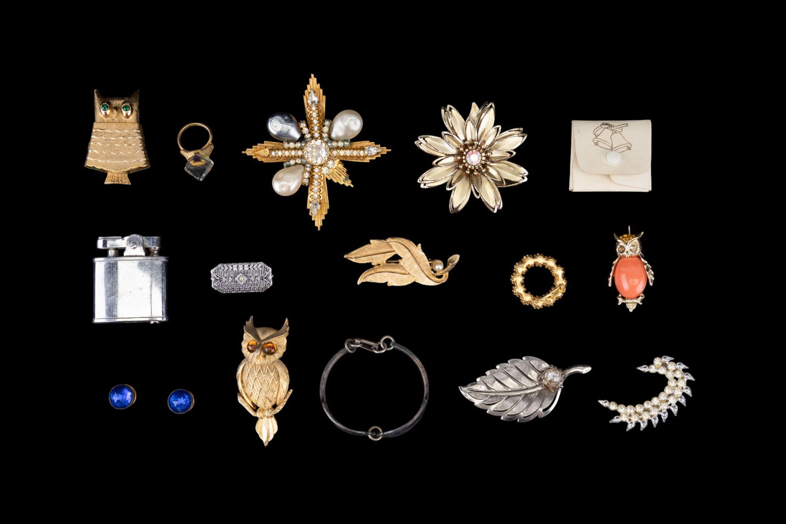 Hattie Carnegie Brooch and Jewelry: Includes a signed Hattie Carnegie cross brooch (missing a stone). Also includes several owl brooches, a lighter, and many other vintage jewelry pieces.