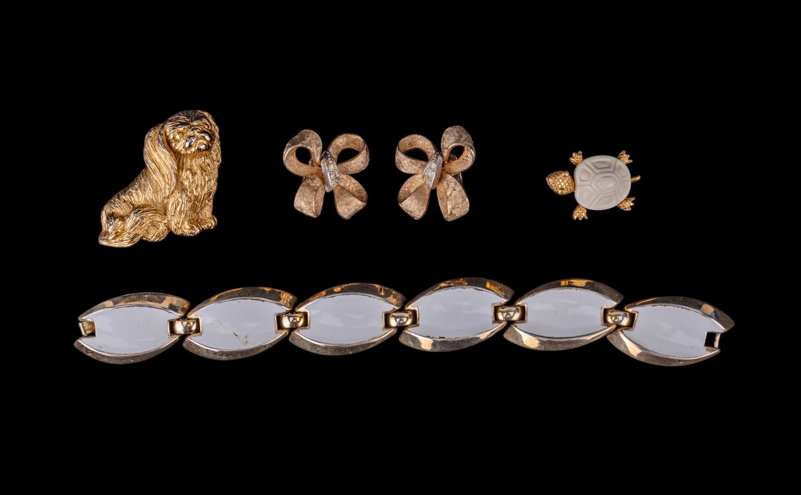 Vintage Coro and Trifari Jewelry: Includes Trifari gold-tone Pekingese pin and turtle pin, and a white enamel Trifari bracelet.