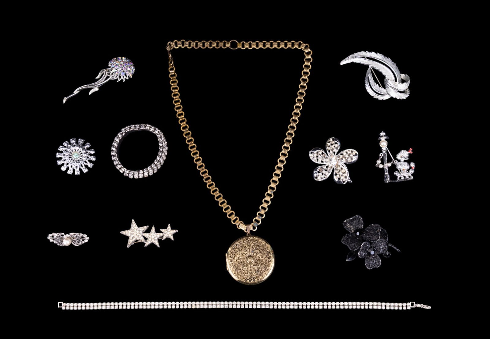 Vintage Art Deco Necklace and Other Jewelry: Includes brass filigree Art Deco locket necklace, along with a variety of rhinestone pins and a bracelet.