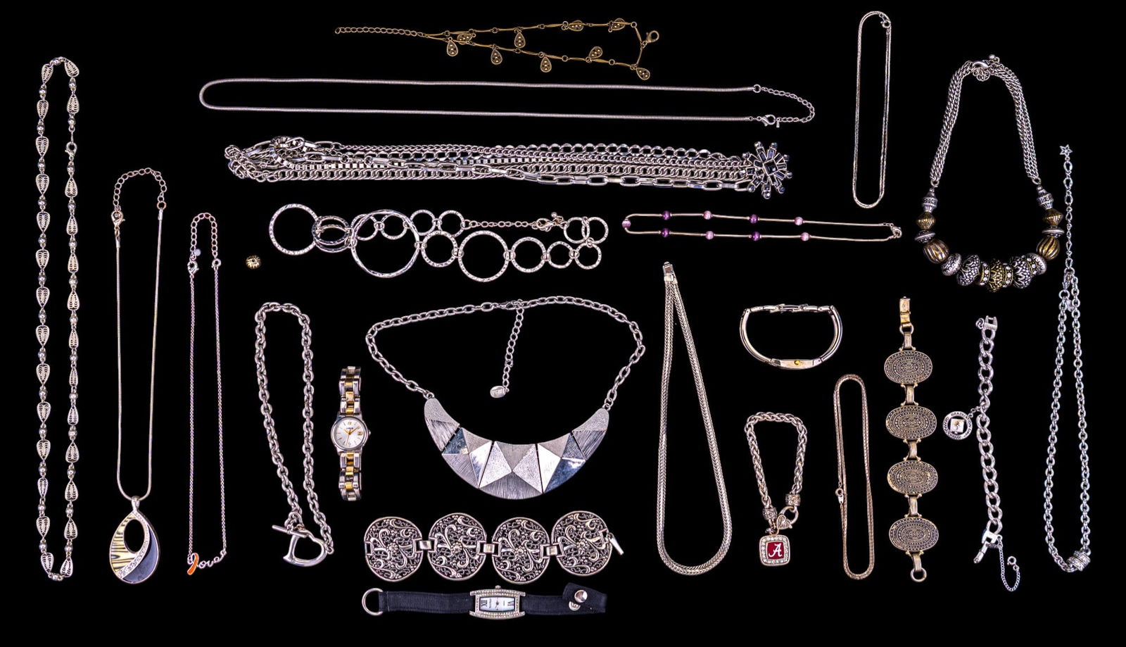 Silver Tone Costume Jewelry, Watches: Grouping of silver tone costume jewelry including a Monet silver tone chain bracelet with graduation day charm, a Lucia silver tone panel statement necklace, Premier designs chain necklace with rhines