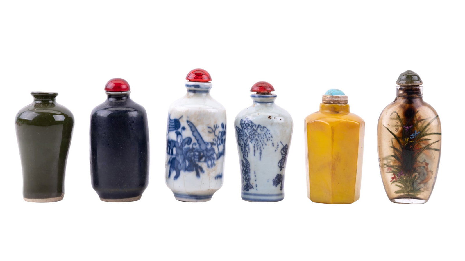 Glass and Porcelain Snuff Bottles: A collection of six Chinese snuff bottles including designs such as yellow Peking glass, blue on white porcelain, solid dark blue and olive green porcelain, and a clear reverse painted glass bottle de