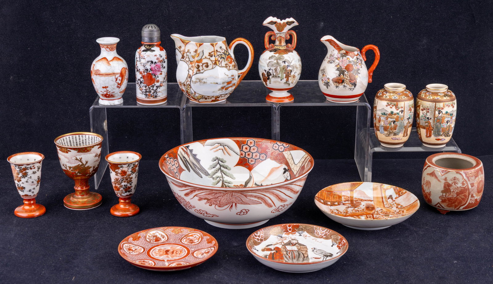 Kutani Satsuma Miniature Porcelain Vases & More: A collection of 15 pieces of Kutani Satsuma porcelain featuring a clove spice shaker, two creamers, three small plates, two cordial glasses, one small wine cup, four vases, a jar with missing lid, and