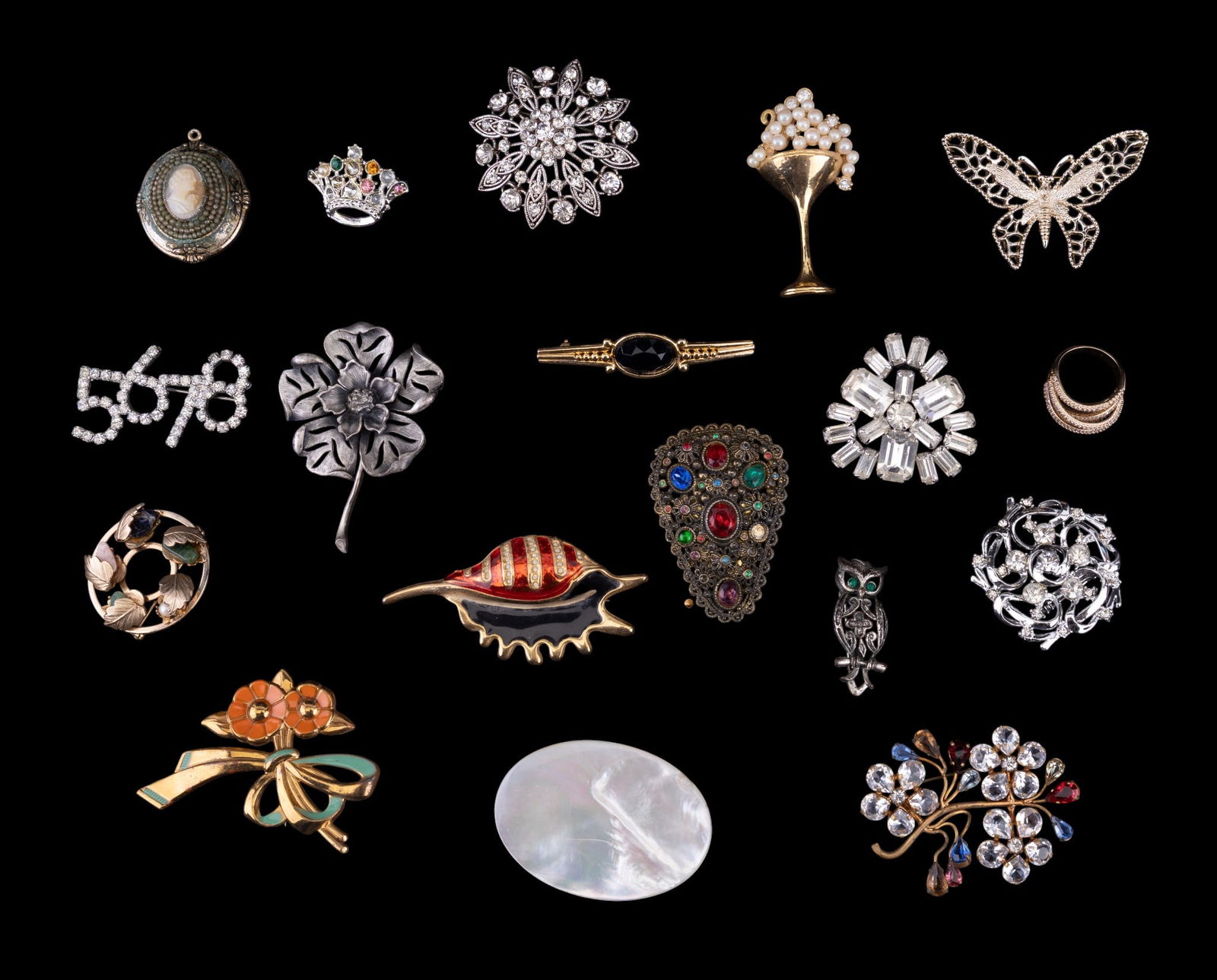 Variety of Vintage Brooches: Includes rhinestone, gold and silver tone, Seashell, a pearl champagne glass, a Coro cameo pendant, and more.