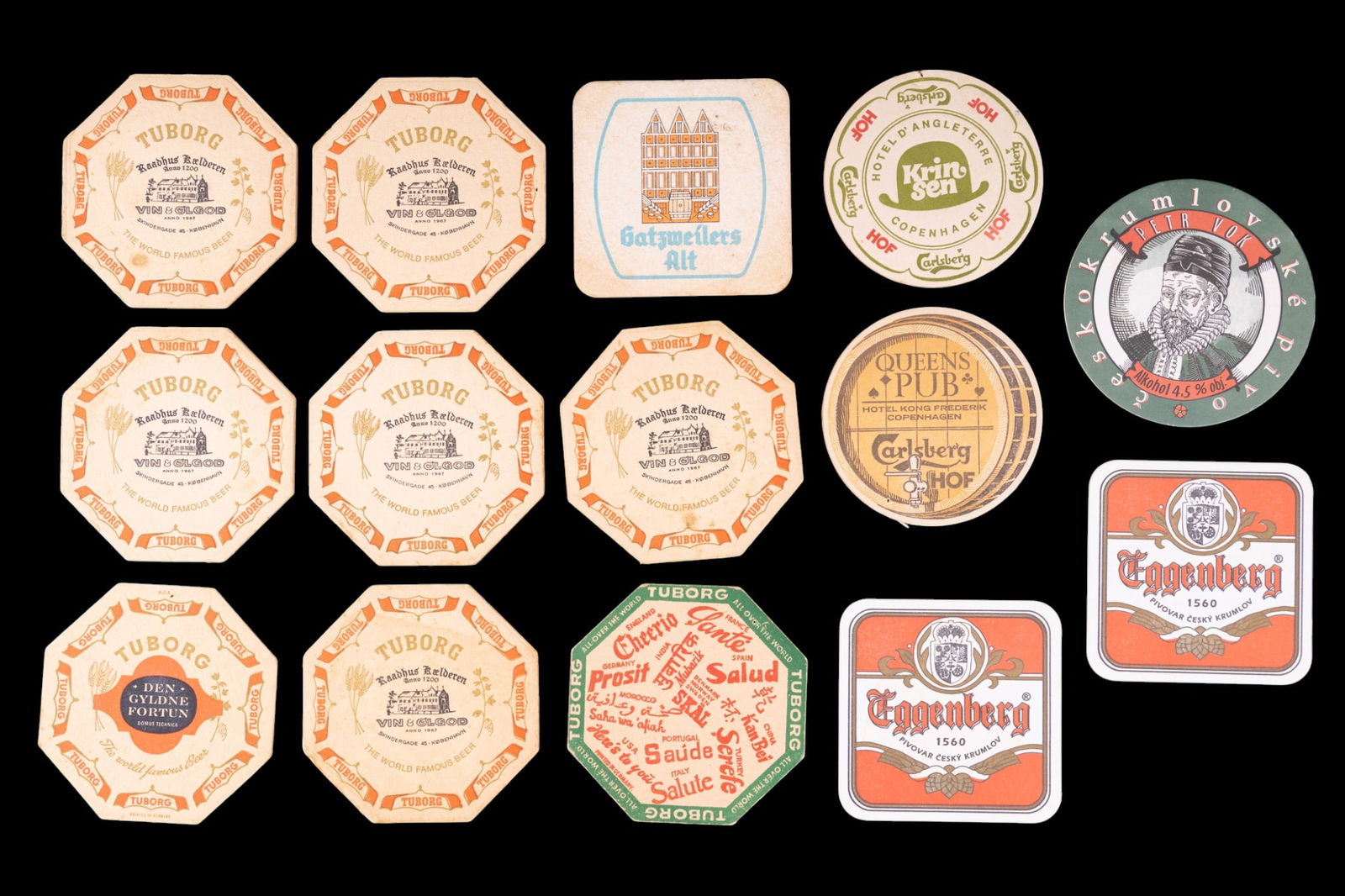 Vintage European Beer and Pub Coasters: A collection of early vintage European beer and pub coasters featuring establishments such as Queens pub at Hotel Kong Frederik in Copenhagen, the Hotel D'Angleterre in Copenhagen, and beer brands suc