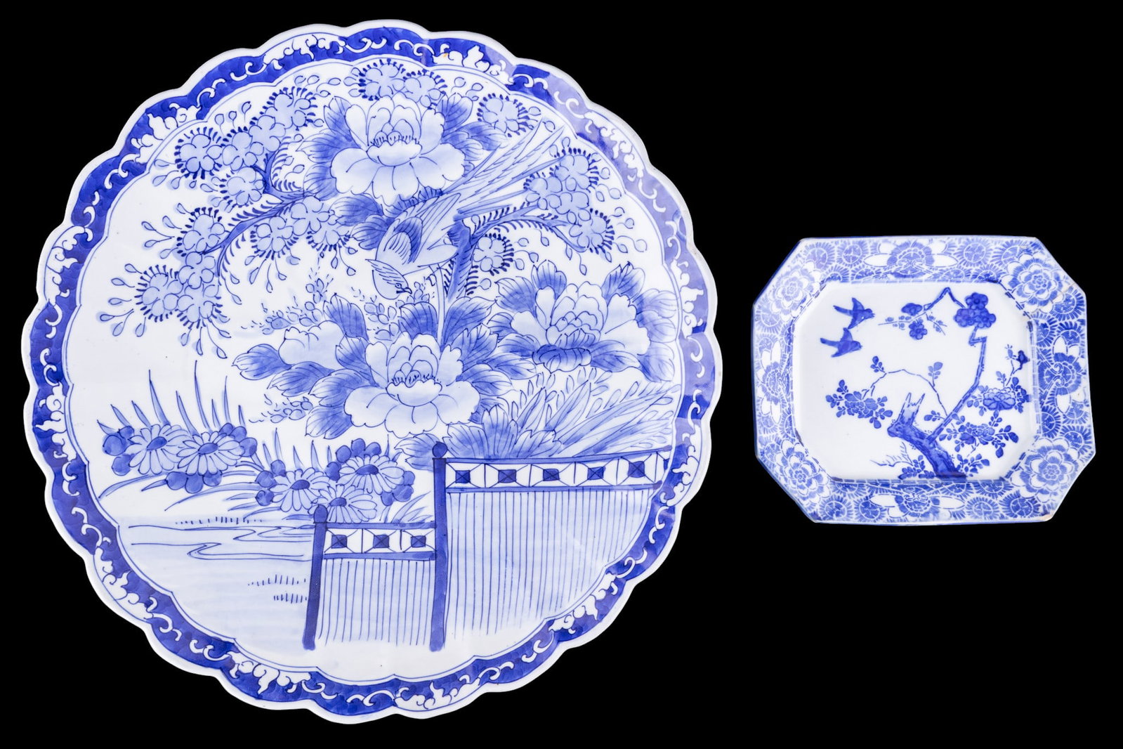 Japanese Blue & White Porcelain: 2 Japanese blue and white porcelain pieces comprising a larged scalloped charger decorated with painted bird-and-floral motif surrouned by a stylized border, and a smaller octagonal plate featuring bi