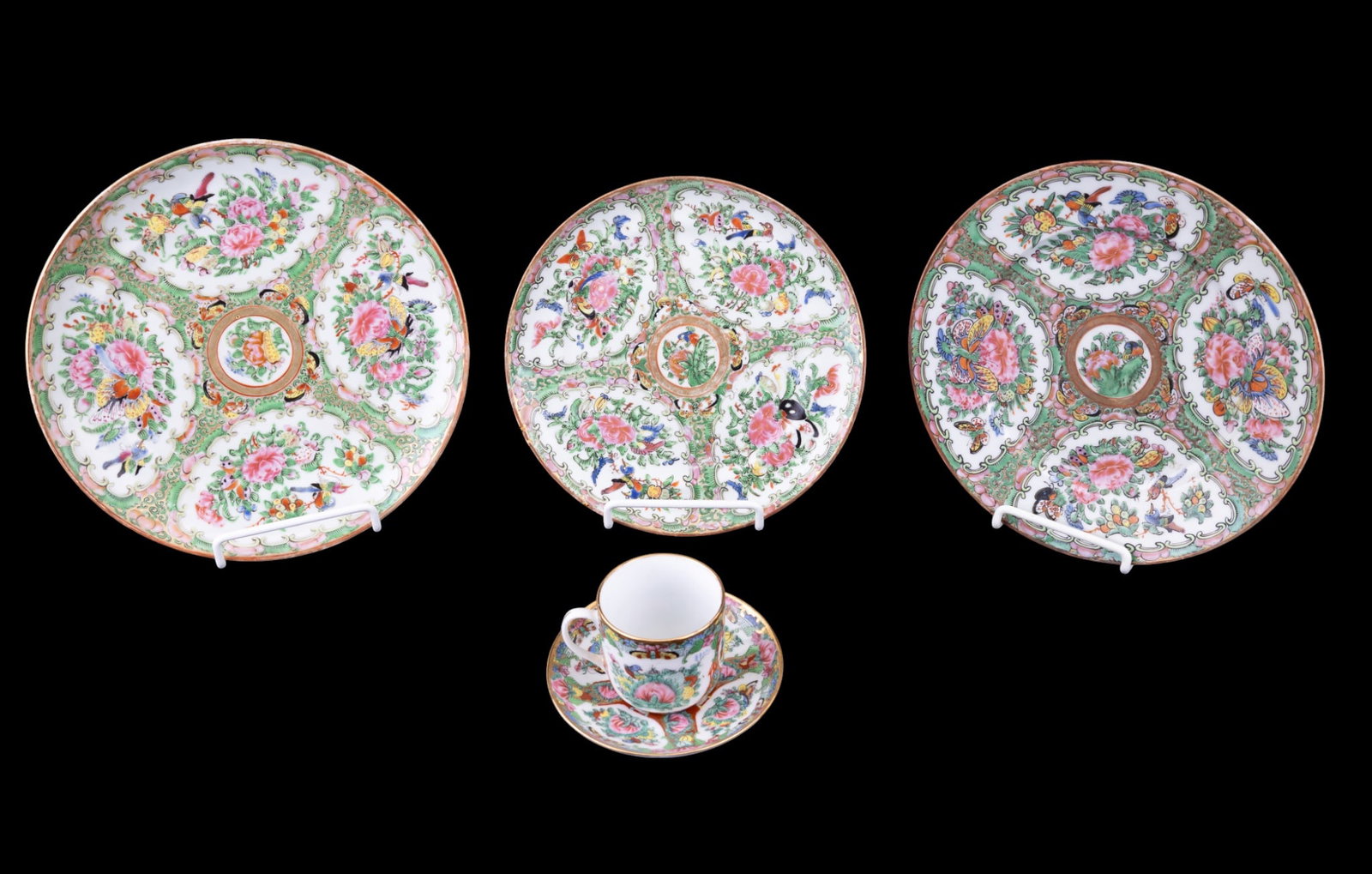 Chinese Rose Medallion Porcelain Pieces: A group of 5 Rose Medallion porcelain pieces, including 3 circular plates, one cup, and one saucer. Each is hand-enameled with alternating floral and figural panels featuring roses, butterflies, birds