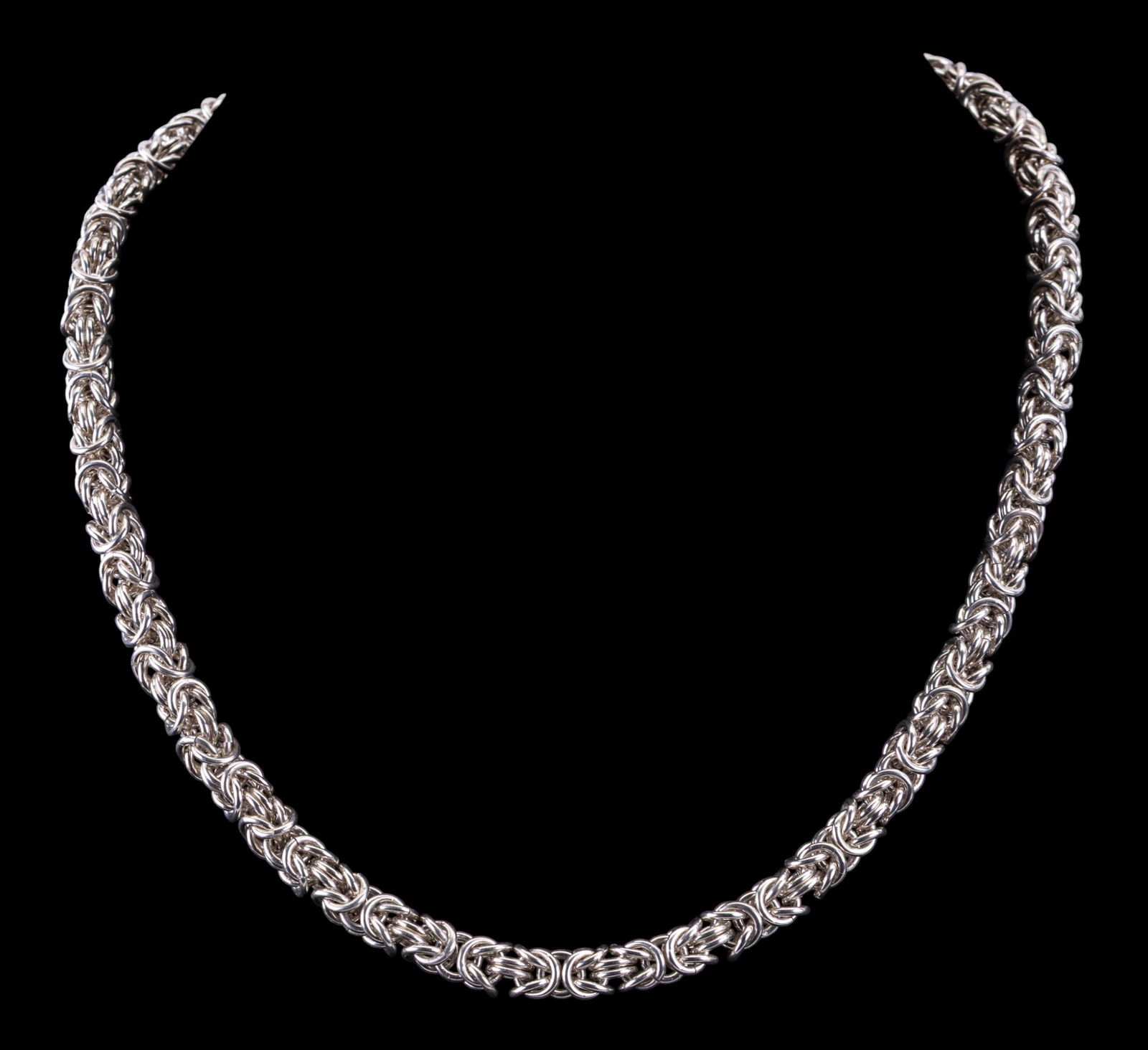 Heavy Sterling Silver Necklace w/ Moonstone: Heavy sterling silver chain necklace featuring an intricate woven link design and set with a round moonstone cabochon accent at the clasp. Weighs approx. 95.5 grams.