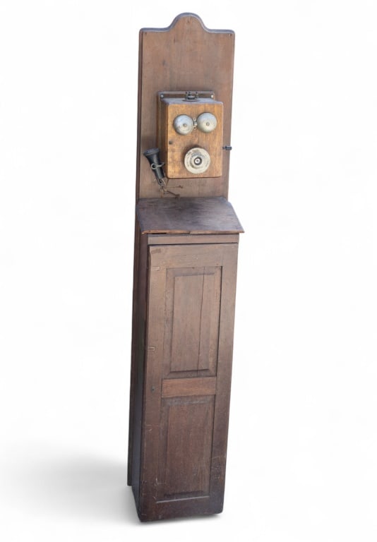 Connecticut & Electric Co. Antique Telephone/Stand: An antique telephone fixture by Connecticut & Electric co. measuring approx. 67" high x 13" w x 9" deep. Two shelves inside fixture.