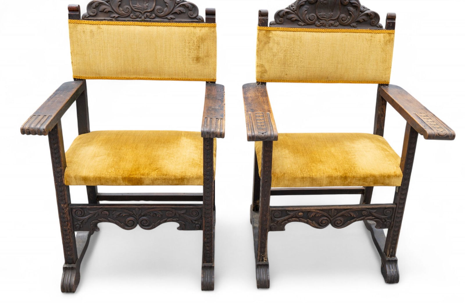 19th C His & Hers Renaissance Revival Chairs (2): A pair of 19th C Renaissance Revival highly carved chairs with family coat of arms on each chair. Chairs are assembled as his & hers with gold color upholstery. Almost sled-style feet. Items measure a