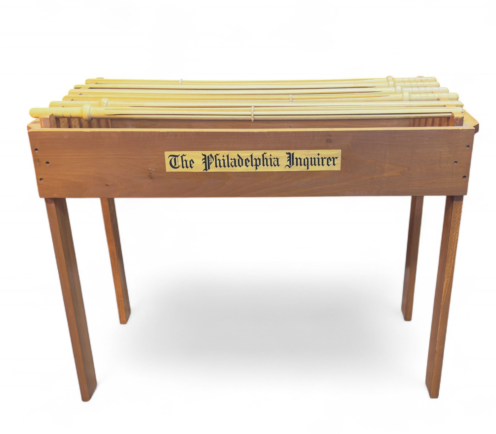 Library Style Newspaper Hanging Rack: A library newspaper rack with 5 spots for 5 newspaper holders / hangers / rods. A removable label is on one side that reads "The Philadelphia Inquirer". Measures approx. 28" H 36" W x 17.5" D.