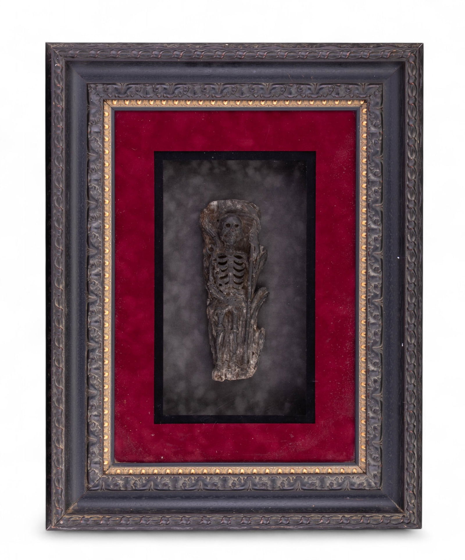Carved Wood Memento Mori Sculpture: Hand-carved wood Memento Mori sculpture depicting a full-length skeleton holding a staff, framed by chains. (held staff may potentially have been a scythe. Measures approx. 10.5" (without frame). Curr