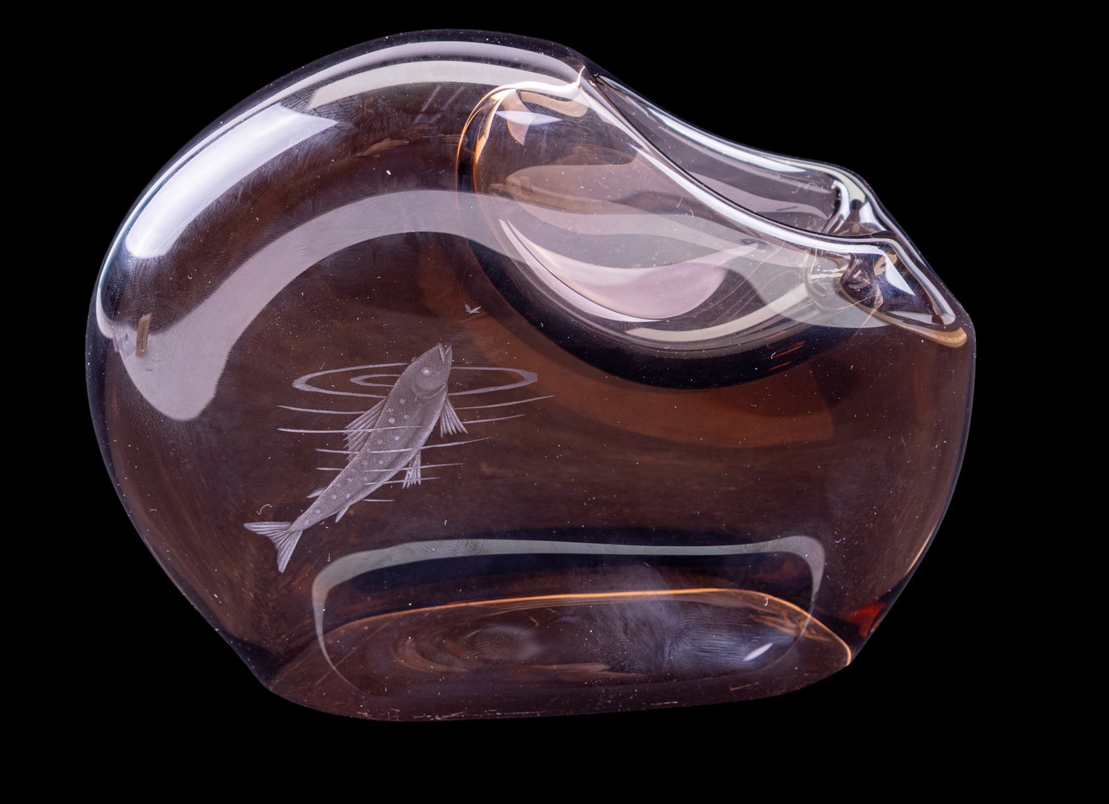 20C Art Fish Etched Glass Ashtray: Early 20th C art glass ashtray, features etched fish emerging from water to get a fly. Stands tall at approx. 5.5" H. One indentation for a cigarette or cigar.