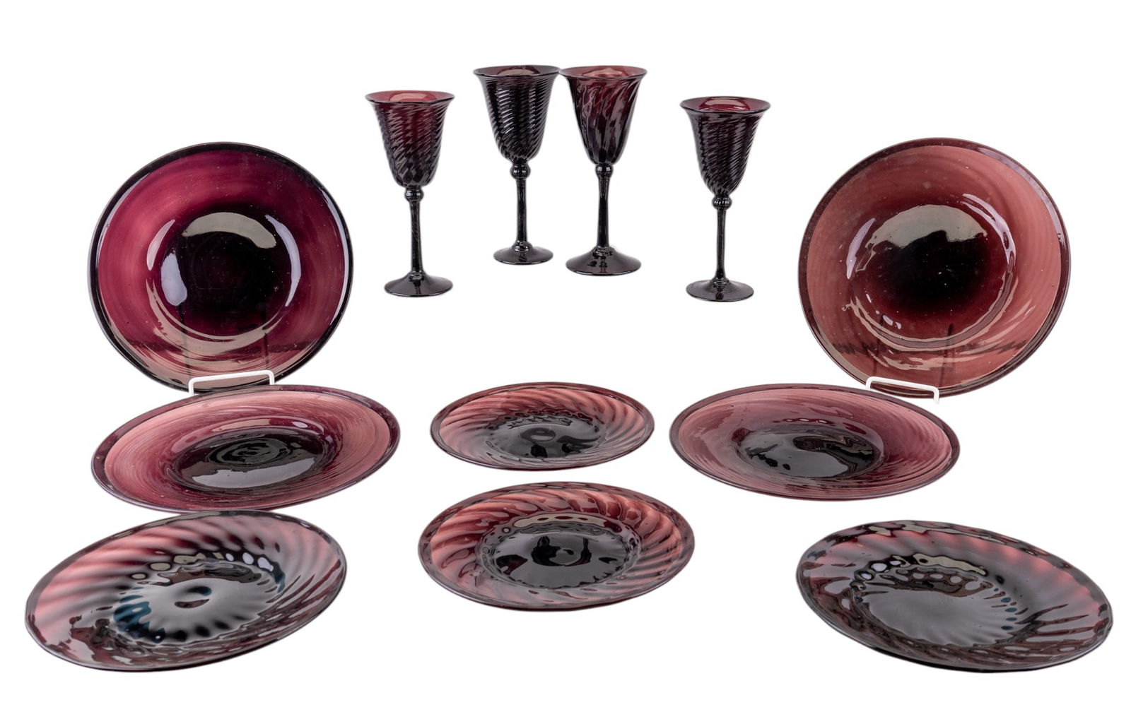 Amethyst Glass Plates, Stemware: Group includes 4 large dinner plates, 4 smaller plates, and 4 wine glasses, each crafted from deep amethyst-colored glass with spiral optic pattern to the stems. Each wine glass measures approx. 8.25"