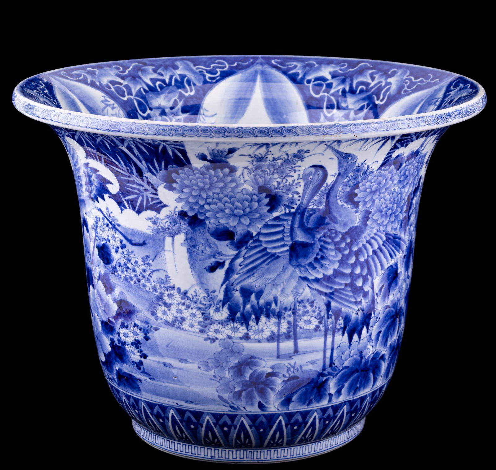 Japanese Blue & White Planter: A Japanese blue & white planter with wide flared rim and deep rounded body. Hand-painted in underglaze cobalt blue with cranes among lotus flowers, chrysanthemums, bamboo, and foliage. Interior is pai