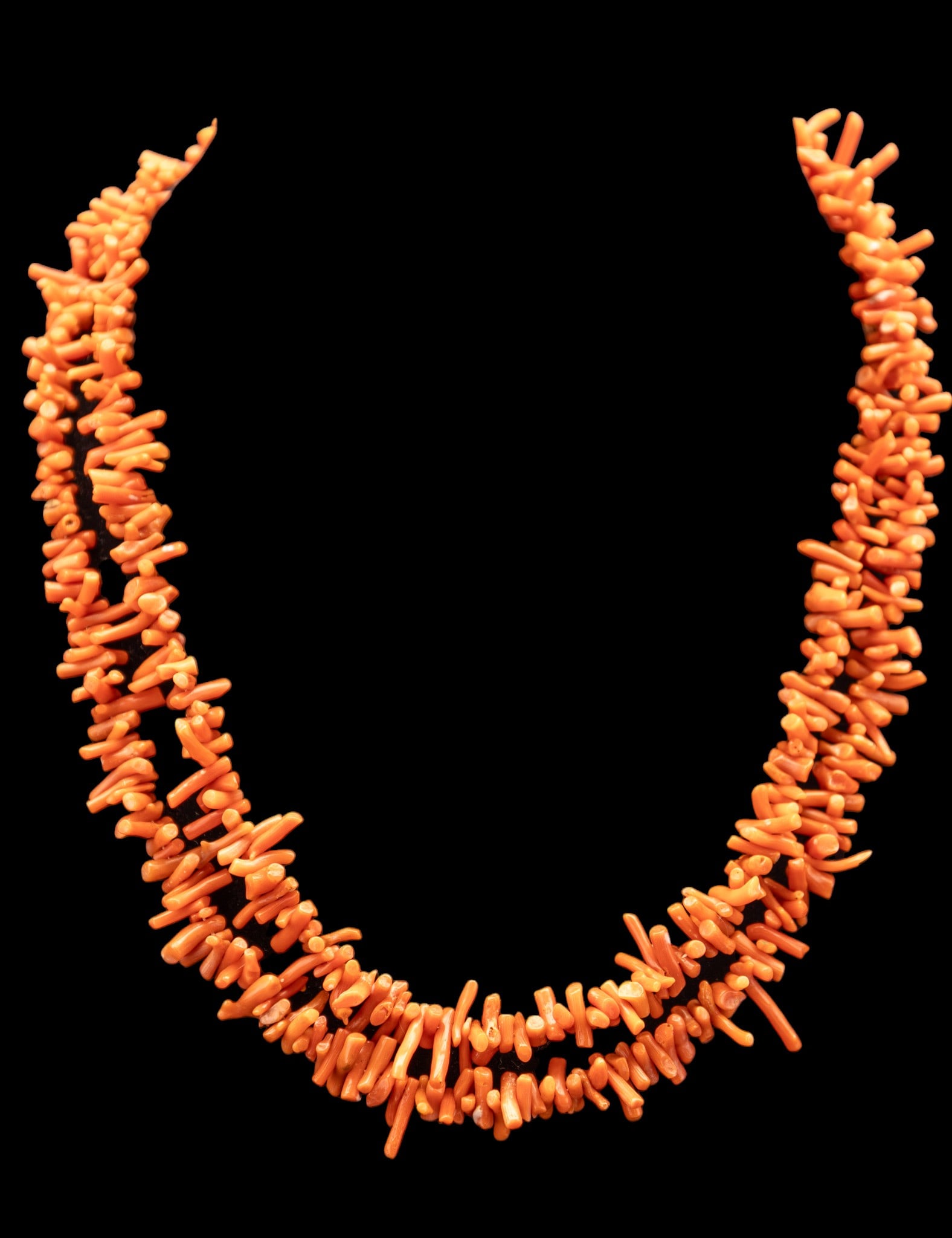 Coral Necklace: Coral necklace in light and dark orange hues, approximately 19" long.