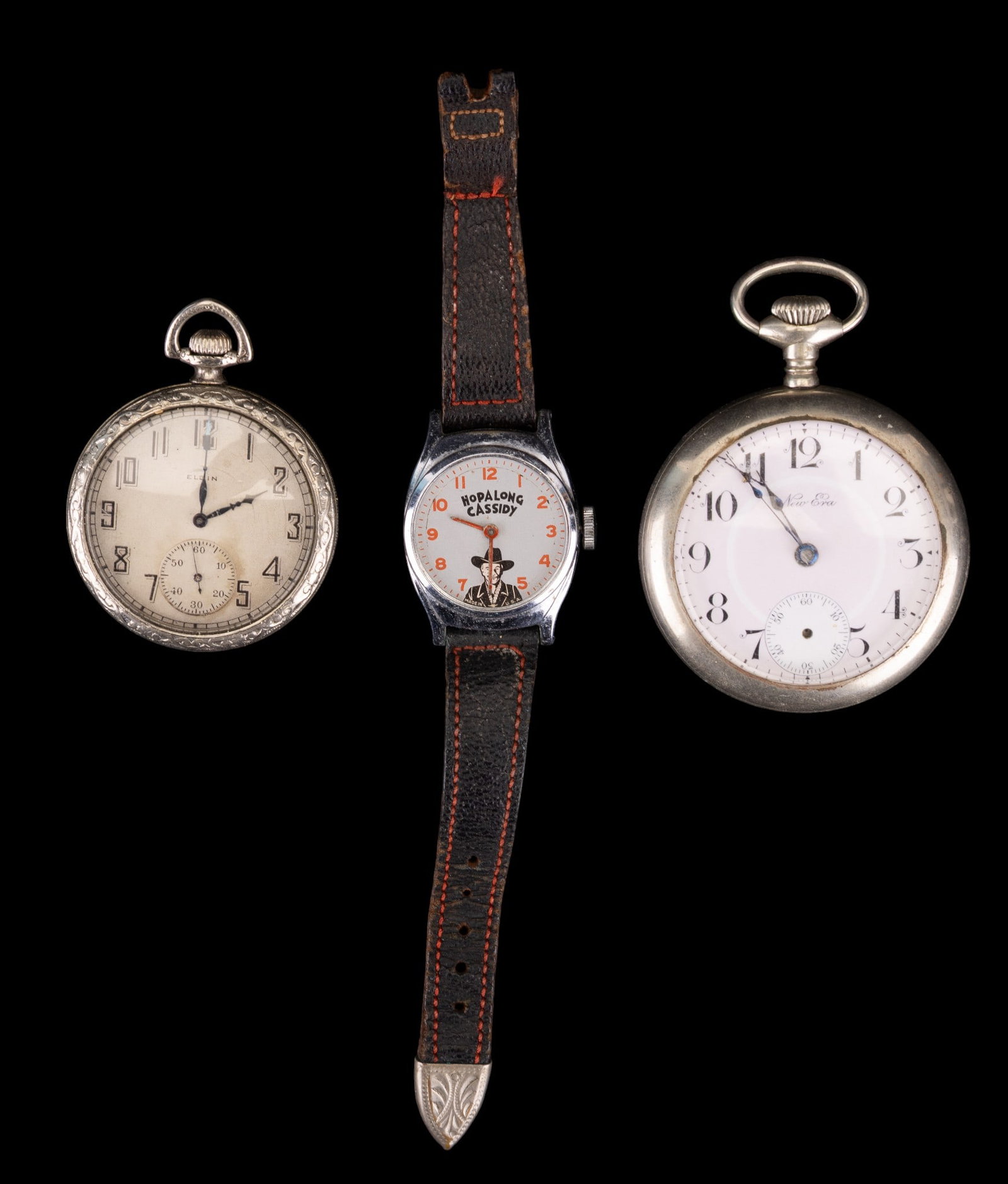 Pocket Watch Lot and More: Elgin pocket watch (S/N 269285912), and New Era pocket watch (S/N AB060686) with stag design. Lot also includes Hopalong Cassidy vintage wrist watch.
