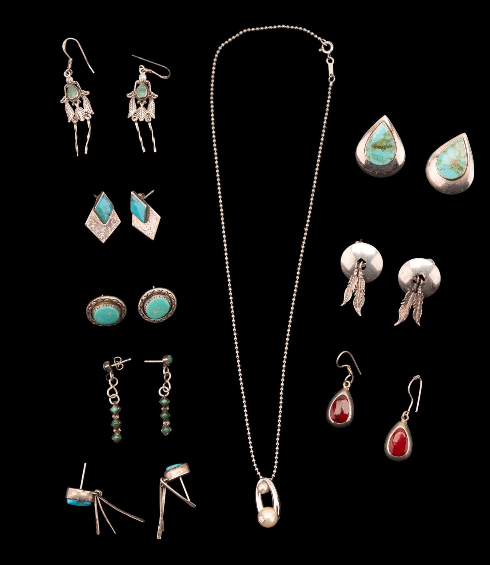 Sterling Silver Navajo Turquoise Jewelry: Navajo sterling silver earrings (8 pairs), some of which include turquoise stones. Also included is a sterling silver and pearl necklace. Approximately 39g