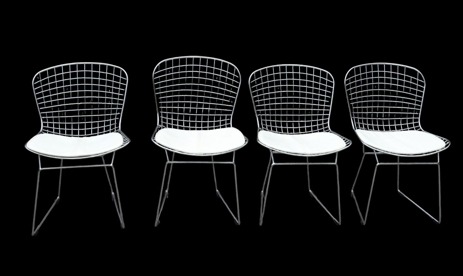 Modern Wire Chairs (4): Set of (4) white modern chairs. Each measures approx. 35" H x 20" seat height, 27" D.