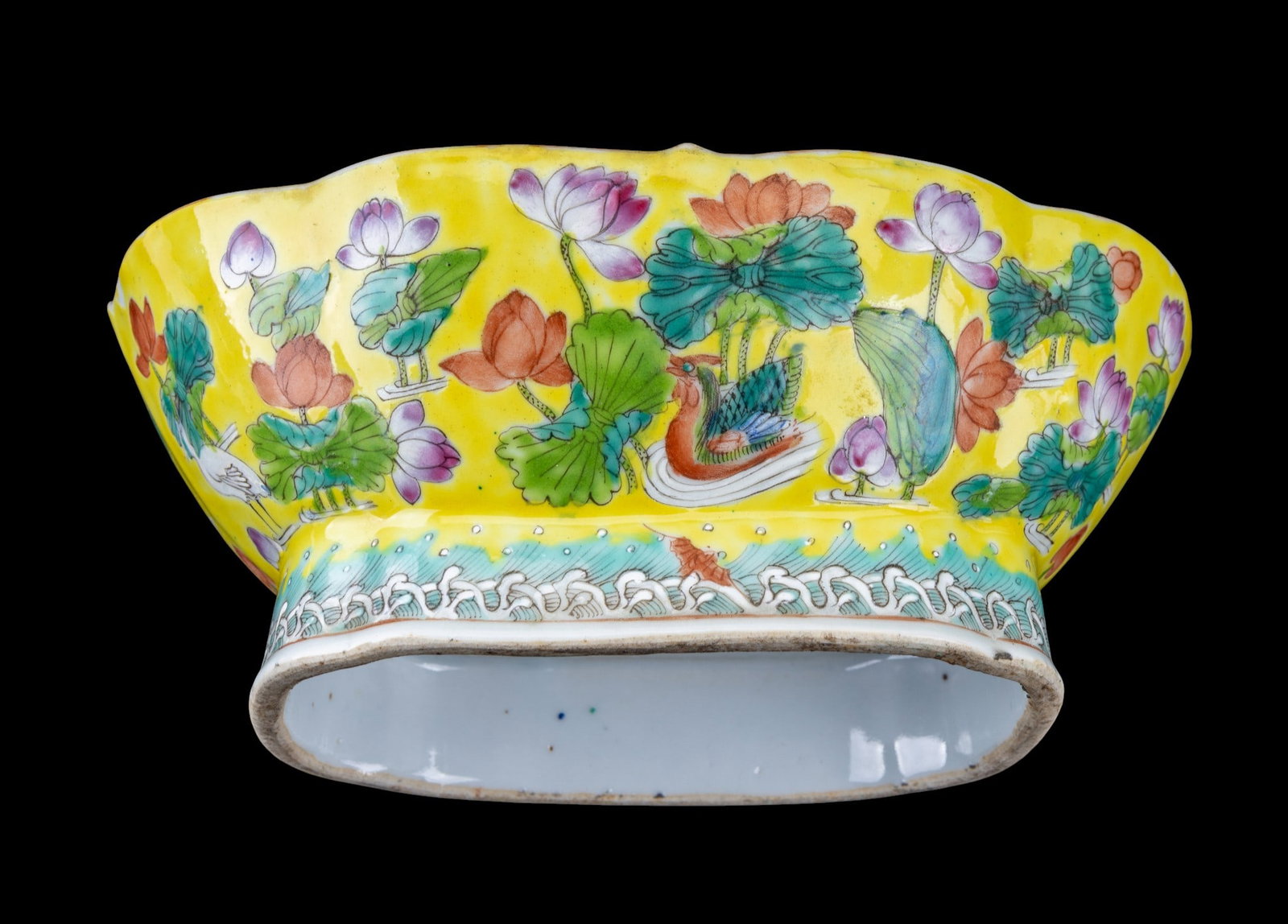 Chinese Famille Jaune Bowl: Large Chinese porcelain bowl finely enameled in the Famille Jaune palette. Features lotus blossoms, scrolling foliage, and mandarin ducks amid waves on a rich yellow ground. Measures approx. 3.5" H x 