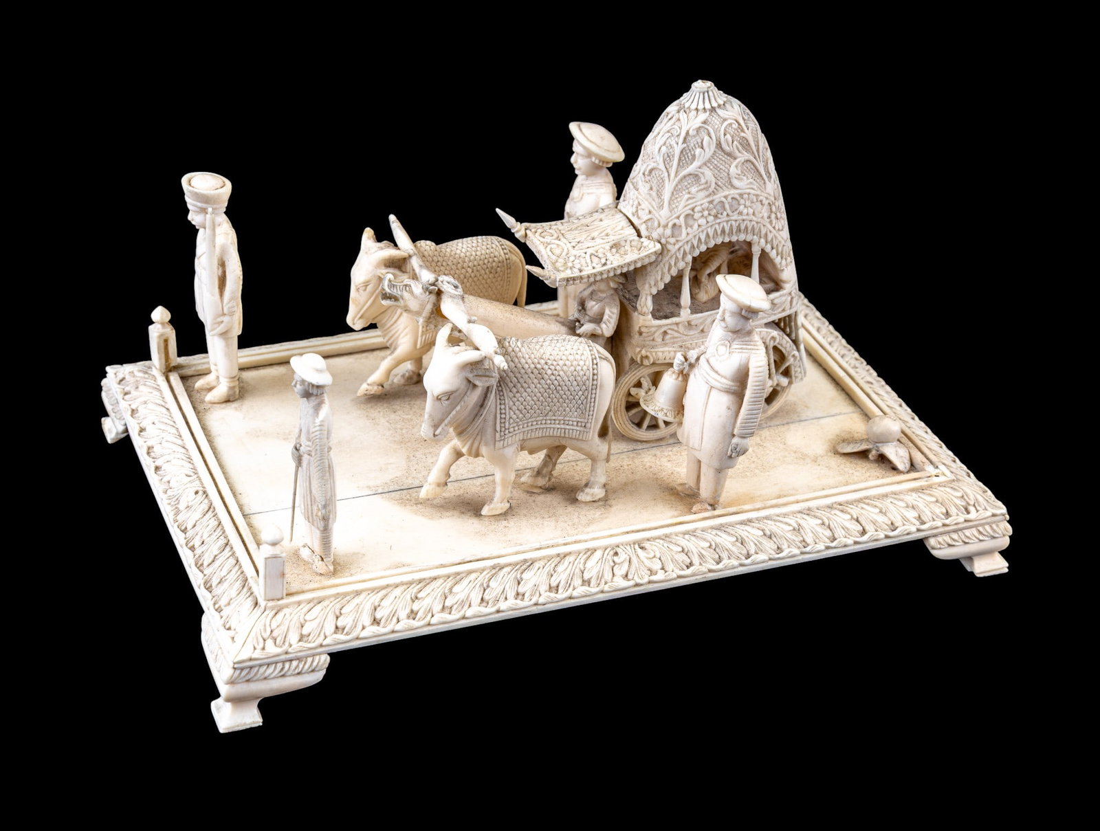 Indian Carved Natural Material Processionals: Fine, highly carved Indian natural material statuette depicting a processional with a cart, guards, and oxen. Measures approx. 8.25" W x 5.5" D x 4.75" H
